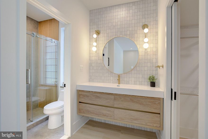 Experience the serenity of this brand-new 2-bedroom, 2-bathroom luxury bayside sanctuary located just one block from the Chesapeake Bay in the heart of North Beach. Thoughtfully designed as an organic modern retreat, this residence offers sophisticated finishes as well as water views from your living room and private front porch. Step inside to discover exquisite features and upgrades throughout, including: MSI "Taj Mahal" waterfall countertop that anchors the sleek kitchen, luxurious gold hardware, custom picture frame wall moulding, and a striking rough-cut Alamo Sandstone fireplace wall that adds warmth to your living space. Each bathroom is finished in a zen-inspired style with custom tile work, designed to reflect a modern spa-like retreat. The primary suite includes a spacious walk-in closet and a beautifully appointed en-suite bathroom. Step outside your door and you're just a block from the beach, boardwalk, restaurants, shopping, cafes, and weekend events. Enjoy the charm of North Beach with the convenience of a quick commute—30 minutes to Joint Base Andrews, 40–45 minutes to Washington, DC, Northern Virginia, and Annapolis. Tour today and discover the best of North Beach living. Broker/owner