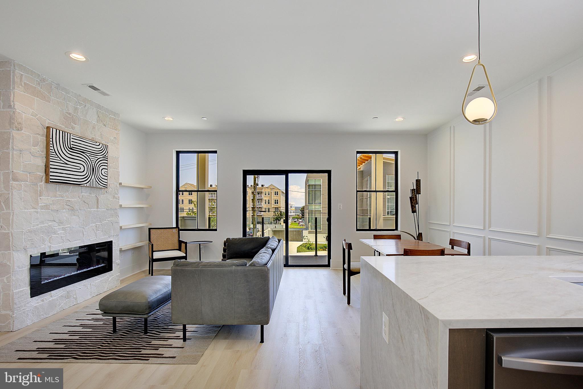 Experience the serenity of this brand-new 2-bedroom, 2-bathroom luxury bayside sanctuary located just one block from the Chesapeake Bay in the heart of North Beach. Thoughtfully designed as an organic modern retreat, this residence offers sophisticated finishes as well as water views from your living room and private front porch. Step inside to discover exquisite features and upgrades throughout, including: MSI "Taj Mahal" waterfall countertop that anchors the sleek kitchen, luxurious gold hardware, custom picture frame wall moulding, and a striking rough-cut Alamo Sandstone fireplace wall that adds warmth to your living space. Each bathroom is finished in a zen-inspired style with custom tile work, designed to reflect a modern spa-like retreat. The primary suite includes a spacious walk-in closet and a beautifully appointed en-suite bathroom. Step outside your door and you're just a block from the beach, boardwalk, restaurants, shopping, cafes, and weekend events. Enjoy the charm of North Beach with the convenience of a quick commute—30 minutes to Joint Base Andrews, 40–45 minutes to Washington, DC, Northern Virginia, and Annapolis. Tour today and discover the best of North Beach living. Broker/owner