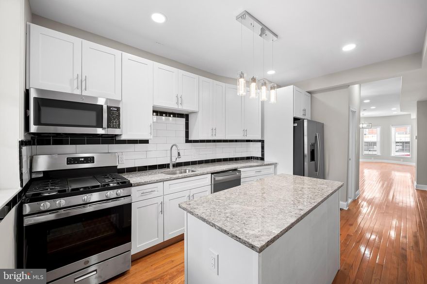 Don’t miss out on this gorgeous, newly renovated home on a block with multiple other homes getting redone (including next door). Featuring 3 bedrooms, 3 full bathrooms, and 1 main level powder room this home is a dream with over 1800 square feet of finished living space. Located walking distance to Johns Hopkins Hospital in the thriving Middle East neighborhood,  this home is in a great location, and near Patterson Park if you like lots of green space. 

The main level is an enormous open living room and dining room that can be designed numerous ways to suit your style. Brand new hardwood greets all your guests and flows from your warm entryway, with a lovely bay window front, all the way through to your kitchen in the rear of your home. Soaring ceiling height adds to the feel of this bright inviting home. Recess lights and tasteful chandeliers add to the sophistication that you’ll find here. The kitchen is decked out with 42” upper cabinets, Stainless Steel appliances and a large prep island all capped with shining granite countertops. Open your rear door to a fenced in private oasis where you’ll enjoy shade from the tree next door and grill in all weather, covered under your rear back covered porch. 

The upper level of your new home offers 3 large bedrooms all with windows to let in the sunshine and fresh air on nice days. The front bedroom is your primary suite with a private bath and rounded front bump out, a rare feature found in just a few homes on this block. The middle bedroom is just across the hall and would be easy access in the middle of the night if used as a nursery. It is also hardwood and could be a beautiful spot for a home office or reading room. Bedroom 3 is down the hall and more private, overlooking the backyard area. Front and rear bedrooms offer plush carpet and a fashionable ceiling fan accents your primary suite. 

The lower level of 738 N. Patterson Park is fully finished, which is a huge deal for Baltimore rowhomes. The ceilings are high and you’ll enjoy luxury vinyl plank flooring from front to rear. Under the stair space is used smartly and is home to the mechanicals for your home- central HVAC, gas hot water heater and sump pump. Towards the middle back you’ll have your 3rd full bathroom, making this a  great area to incorporate a guest bedroom. There is an exit to the back yard as well. The rear room will be home to your laundry area and extra storage. 
Across the street to the North you’ll find the Henderson-Hopkins Elementary school with its new Athletic Field that keeps a great look to the block. Madison Avenue to the South is a bustling commerce area with all types of shopping and restaurants and it is easy access to public transportation. First time home buyers be sure to check into or ask more about the multiple home ownership grants that you could take advantage of and make home ownership even more achievable.