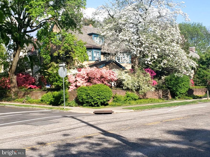 Welcome to this exceptional 1929 Cotswold Cottage with Sunny Southern Exposure located on a most desirable tree-lined street in East Falls! 

Classic 1929 Corner twin property features 5 Bedrooms, 2 Full Baths, 3 Fireplaces (1 Decorative) designed with the classic Front and Back Staircase in the heart of historic East Falls located off Kelly Drive. Live among Philadelphia’s storied past, designed by distinguished architect, Lawrence Visscher Boyd in 1911, this was his personal home and has been lovingly cared for by the same family for 36 years. 

Main floor welcomes you to a 3-Season Glass enclosed Brick-paved Patio with wall-to-wall windows; a lovely room to curl up with a book and enjoy the Azaleas, Rhododendron, Roses and established mature perennials. Entry Foyer opens to gracious Living Room with wall of Curved Glass Windows, the focal point is the Wood-burning Fireplace with the distinguished Mercer Tile surround, Built-Ins Bookcases, architectural Crown Molding and original hardwood floors add warmth and character. Adjoining Dining Room boasts expansive Bay Windows, architectural Crown Molding & double French Doors creating a well-designed space for entertaining.
Eat-in Kitchen has generous cabinetry and counter space to enhance both functionality & storage with Bosch Dish Washer, 4-burner Gas Range. Breakfast area overlooks private Patio ideal for Gas-grilling and relaxing in a rare urban oasis with charming gardens, mature perennial shrubs to enjoy Wildlife sightings of Owls, Red Fox, Deer and Songbirds. A tucked staircase leads directly from the kitchen to the upper floors.

2nd floor has 2 Bedrooms and a Full Bath, including a spacious Primary Suite & large Walk-in Closet, 2nd Bedroom has built-in Day Bed, generous closets and wood-burning Fireplace. 3rd Bedroom with deep closet & large Bay Window complete this level. 3rd floor has Two additional Bedrooms, decorative Fireplace, an open landing Sitting Room with great natural light, Full Bath, and Kitchenette; ideal for guests, Nanny or In-Law Suite. The expansive basement offers excellent storage or creative workshop and includes exterior walk-out access. 

This gracious home offers timeless character, exceptional space, and unbeatable convenience in one of Philadelphia’s most sought-after neighborhoods, just off Kelly Drive, walk to McMichael park, Wissahickon & Schuylkill River Trails; perfect for biking, running, walking trails, Collegiate Sculling, watching the Dad Vail Regatta AND an amazing sledding hill - fun for kids and adults! 
Retail stores, fabulous local Restaurants, Cafes, Coffee Shop and Florists. Enjoy the Saturday farmer’s market, vibrant community events, Community Theater and live music at The Fallser Club. Effortless commute to the Suburban and Amtrak station just 10 minutes away.

This home radiates warmth, character, craftsmanship and offers endless possibilities for the next lucky owners to revamp and modify.
Experience the convenience of city life with the charm of green space and a lovely neighborhood feel with quick access to Fairmount Park, Center City, University City, Chestnut Hill and the Main Line, as well as local hospitals and universities. East Falls delivers the convenience of city living with the peaceful feel of a tucked-away suburban Cotswold Cottage.