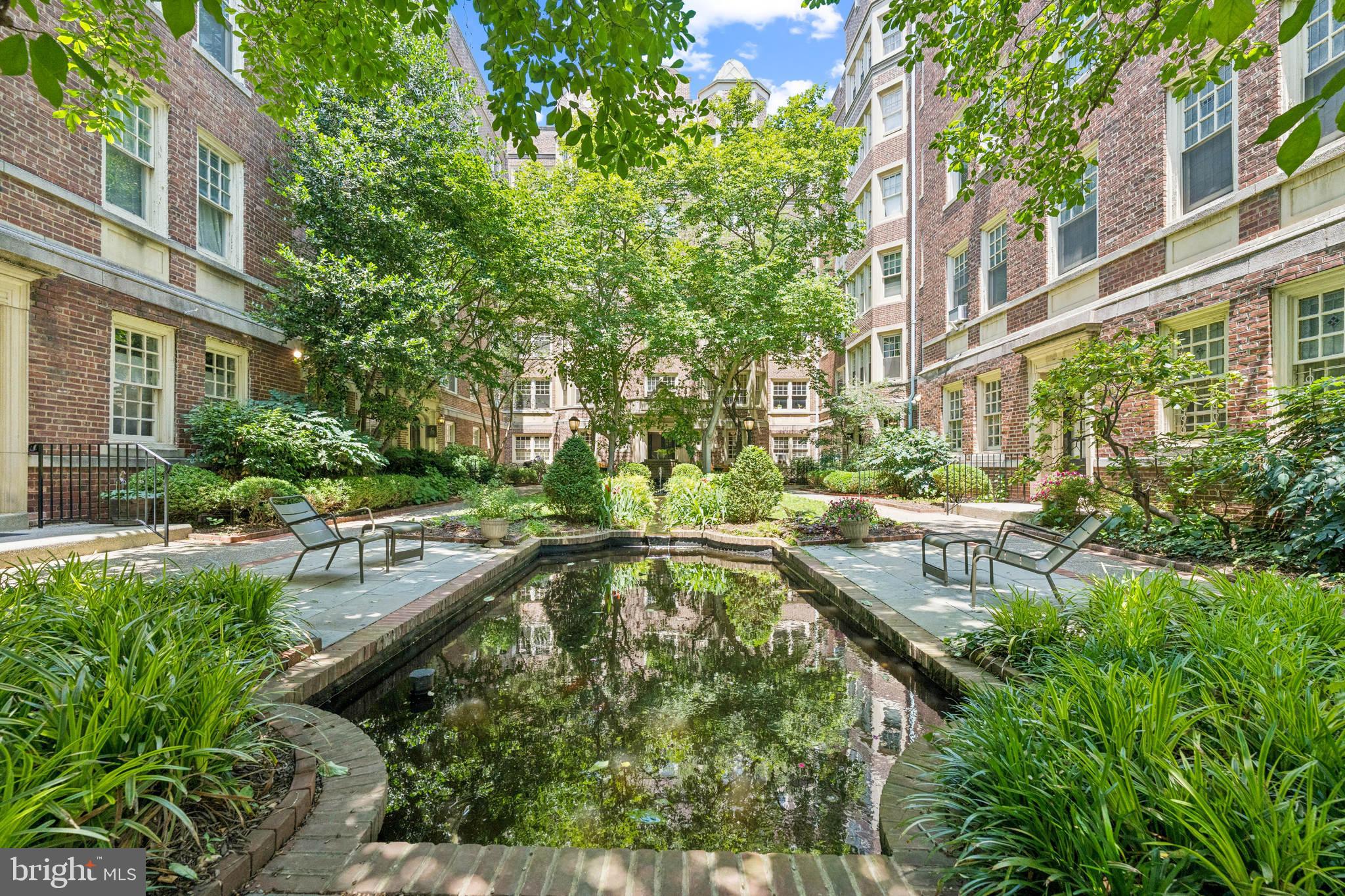 This one bedroom, one bath condo in the Historic Garden Court Condominium building is perfect for anyone seeking a peaceful location close to so much. Your condo fee includes access to a well-equipped gym, party room with pool table, lending library, heated indoor pool , heat and hot water. It includes a combination washer and dryer.
Built in 1923, the building retains the art deco charm of that era. The iron gate opens to a landscaped courtyard with koi pond. The location is ideal for someone who wants to be close to the University of Pennsylvania or Drexel University. Public transportation is close by. Take a 3 minute walk to the 42 bus and you can be at the U Penn Hospital Complex or U Penn campus in less than 20 minutes. 30th St. Station for Amtrak and Regional Rail is 25 minutes by bus. The center city shopping district and Rittenhouse Square are a short walk and bus ride away. Special assessment scheduled to end by Dec. 31, 2025