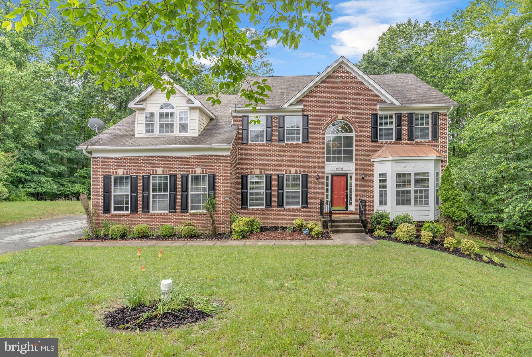 Nestled on over five private acres, this stately all-brick Colonial offers over 6,000 SQ FT of living space for the whole family. A side-load two-car garage welcomes you, while the maintenance-free deck and brick paver patio in the rear provide the perfect backdrop for outdoor entertaining or peaceful retreat—all overlooking a serene, wooded setting. Step through the front door into a stunning two-story foyer featuring rich hardwood flooring and a designer chandelier that sets an immediate tone of sophistication. To your left, a formal living room boasts plush carpeting, oversized crown molding, and a charming bay window. To the right, a refined dining room showcases a designer chandelier, wall sconces, chair rail, crown molding, and elegant carpeting—ideal for hosting intimate dinners or holiday gatherings.
Nine-foot ceilings grace the entire main level, enhancing the sense of openness throughout. The hardwood staircase in the foyer adds a grand touch, while a secondary rear staircase from the kitchen provides added convenience. A well-appointed main level powder room features hardwood floors, and a private office with wide-plank hardwood, a decorative chandelier, and glass door offers the perfect space for working from home. At the heart of the home is a dramatic two-story family room, anchored by a gas fireplace with marble hearth and surround, a marble-topped mantel, and custom remote-control blinds adorning the soaring windows. Crown molding with recessed lighting and elegant carpeting (with designer hardwood beneath) complete the ambiance. The chef’s kitchen is a showstopper—equipped with granite countertops, stainless steel appliances, 42" cabinets with pinstripe and glass-front doors, a gas cooktop island, built-in wall oven and microwave, tile floors, designer lighting, and a custom mirrored backsplash. It opens to a bright and spacious sunroom with crown molding, ceiling fan, plantation blinds, and a door that leads to the expansive deck and patio area.A practical laundry room with two closets, a laundry sink, and access to the garage adds convenience to the main level. Upstairs, the hardwood hallway leads to 4 generously sized bedrooms, all with ceiling fans and hardwood floors. The catwalk provides dramatic views of both the foyer and family room below. The owner’s suite is a true retreat, featuring a vaulted ceiling, recessed lighting, ceiling fan, separate sitting area, and even a dedicated shoe closet. The luxurious ensuite bath boasts dual vanities, an oversized jetted tub with tile surround, step-in shower, recessed lighting, and dual walk-in closets with professional organizers and hardwood flooring. The finished basement expands your living space with a large open recreation room, LVP flooring, recessed lighting, antique pool table, and a marble-topped wet bar—perfect for entertaining. A full bath and a flexible bonus room (ideal as a gym, media room, or second office) provide additional functionality. Practical upgrades include a gas furnace and water heater, whole-house water filtration system, and sump pump with battery backup.