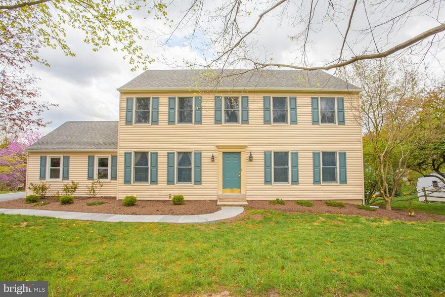 Pride of ownership shows in this completely updated 4 bedroom center hall colonial located in desirable Merlin Hills.  This home sits on more than   of an acre with more than 2900 square feet of living space. The kitchen has been completely renovated with Kraftmaid cabinetry, quartz countertops, breakfast bar, Custom Closets by Design pantry, new stainless steel dishwasher and range. Kitchen flows into 16 x 20 sunroom that is drenched in sunlight surrounded by 3 walls of casement windows and Anderson sliding door that leads to  the deck.  Enjoy the deck in full sun or use the remote controlled retractable awning for shade while you enjoy the views of the lush yard.  The family room is open to sunroom and kitchen with a brick fireplace and a 6-stage gas fireplace insert.  Spacious living room, dining room, and powder room complete the first floor.  The second floor features large master bedroom with newly remodeled on suite bathroom, and a walk in closet.  The wide central hallway leads to 3 generous sized bedrooms and updated hall bathroom.  Walk up stairs to full footprint stand up attic for storage with a thermostatic controlled solar attic fan. Walkout basement is partially finished with custom built-in bookcases, a workshop area, and additional basement space under the sunroom addition. The side entry 2 car garage is insulated, dry walled, and has built in storage. Additional features include custom Closets by Design, whole house generator, walk up attic,    insulated siding, bluestone front walkway, new windows and sliders, security system and water softener.