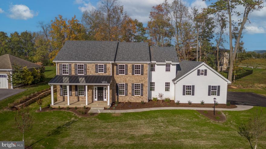 Extraordinary new construction, modern farmhouse style, situated in the highly sought-after neighborhood of Stearns Crossing. This picturesque community is renowned for its breathtaking views, expansive landscapes, and distinctive homes. Set on a remarkable .58-acre lot, this meticulously crafted home by Steve Hackman Builders boasts luxurious finishes and memorable amenities. Enter and be greeted by 9' ceilings on the main floor and engineered wide plank wood floors. The interior is adorned with exquisite built-ins, charming shiplap details, and an array of stunning lighting fixtures. Transom windows and French doors add an elegant touch. The kitchen is a culinary pleasure, featuring custom cabinets, honed quartz countertops, and high-end Frigidaire Professional appliances. A generous island/breakfast bar and a convenient wet bar with a beverage refrigerator make this space perfect for entertaining. The open-concept design leads to a spacious family room, highlighted by an expanse of windows and a floor-to-ceiling stone fireplace with custom concrete surround. A peaceful study with handsome built-ins and French doors, a formal dining room, flex room, beautiful foyer, exceptional pantry, laundry room, half bath, and mudroom with organizers complete the main level. Upstairs, the primary bedroom suite offers stunning views of the very private backyard and a luxurious full bath with dual sinks, a soaking tub, tile shower, and radiant tile floors. The second bedroom has a private full bath, while the third and fourth bedrooms share an ensuite bathroom. The upper level also boasts a versatile family/loft area and a second laundry room option. There’s more! The finished lower level offers even more living space, including a media room, egressed gym/playroom, bedroom, and a full bathroom. Step outside onto the inviting covered porch and appreciate the beauty of the surrounding trees and landscape. Additional features of this remarkable home include the stunning stonework on the exterior, a three-car, side-entry garage with convenient steps leading down to the lower level, Superior Walls construction, and a prime location near campus and other local attractions.