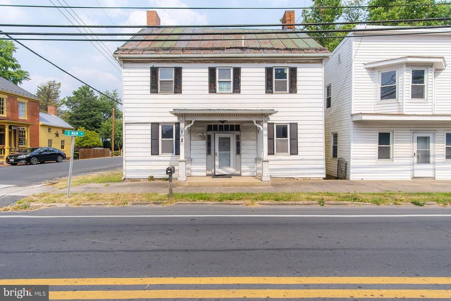 Located in quaint and quiet Woodsboro, this parcel includes 2 separate homes, plus12 garages on a .37 acre corner lot. One of the homes is setup as a single family home and the other home as a duplex. The homes have been unoccupied for 4 years and need total renovation. There are no kitchens and the bathrooms need updated. Wood floors need refinishing and most of the floors are just subflooring.  These homes are a blank slate, ready for your renovation.  The corner house at 2 Main Street has 3 bedrooms and 1 bathroom and is close to 1,900 sq. ft. on 2 levels. The owner has identified the second detached home as 4 and 6 Main Street. This detached home is set up as a duplex with both sides being around 1,050 sq. ft. on 2 levels, each with 2 bedrooms and 1 bathroom.  The rear yard is flat and spacious with off-street parking that could accommodate 6 cars.  A large detached garage is on the rear of the property that fronts both the side street (E. Elizabeth) and the rear street (S. Second) and includes 12 bays; all are fully rented at $75 each or $900 total per month.  This property and these 2 homes have been priced based on their present condition and potential rental income.