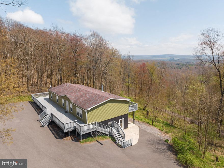 PRIVATE MOUNTAINTOP RETREAT - 3BR, 4BA on 4 acres, less than a mile from Deep Creek Lake! Impressive property with fantastic views & scenic vista. Well maintained and incredibly private setting.   GIGANTIC wrap-around deck, paved access road, driveway and a parking area large enough to accommodate ALL of your guests! Lower level finished basement is perfect for entertaining. Sold FURNISHED!