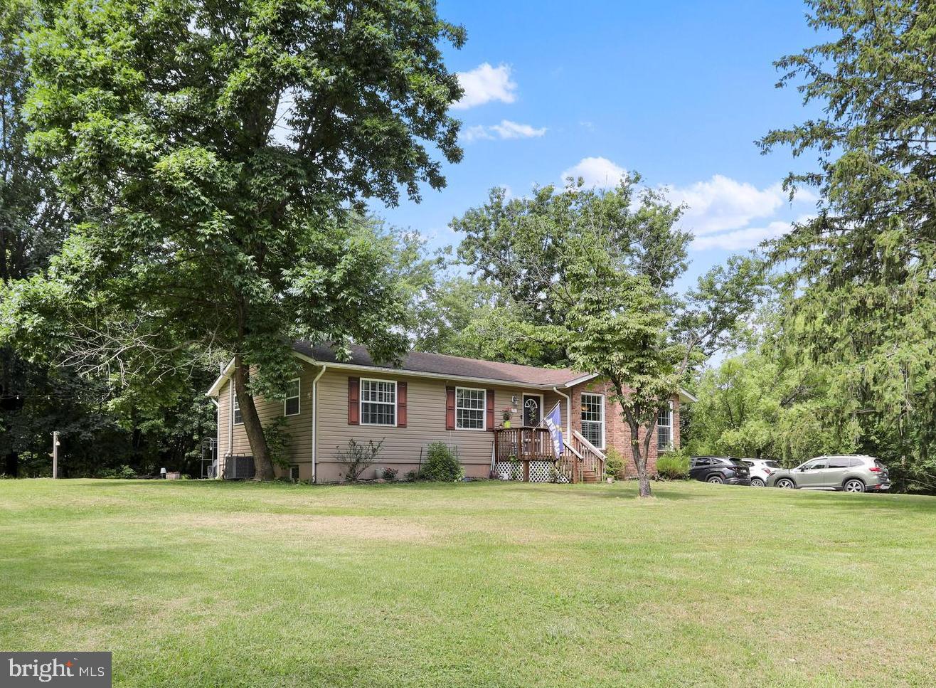 Tucked into a peaceful, wooded setting with flat, usable yard space, this spacious mountain ranch-style home offers the perfect blend of comfort, charm, and versatility, with over 2,500 square feet of finished living space and priced below appraised market value. The main level features a large primary bedroom with a private ensuite bath, along with two additional bedrooms and another hallway bathroom. The heart of the home features a cozy living room with a gas fireplace and an inviting kitchen equipped with a gas stove, ample cabinet storage, a spacious pantry, and a sliding barn door for added character. Just off the main living area is an incredible sunroom with a pellet stove for the colder months and a ceiling fan to keep things breezy in the summer, making it an ideal year-round retreat. <br><br>
The fully finished basement offers impressive additional living space and even the potential for a bedroom setup. It features a spacious rec room with a pool table that conveys, a wet bar, full-size fridge and freezer, and a cozy woodstove for those chilly winter nights. There’s also a laundry area with a utility sink and convenient walk-up access to the backyard. Step outside to a flat, open space perfect for entertaining, and don’t miss the private hot tub nestled on its own deck, seamlessly integrated into the landscape for ultimate relaxation.
<br><br>
The house is serviced by public water, and a recent septic inspection and pumping were completed in June 2025. Additionally, the property features propane gas, high-speed Xfinity internet, and multiple storage sheds that are included in the sale. It is ready for modern living in a mountain setting. Whether you’re entertaining, relaxing, or working from home, this thoughtfully designed property has the space, updates, and setting to make it all possible. Don’t miss your chance to own a beautiful mountain retreat with serious style and substance. <br><br>