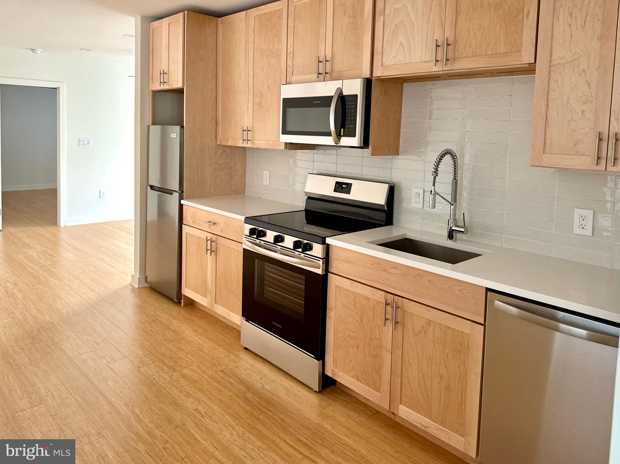 Be the first to live in this bright, brand-new 1-bedroom, 1-bath apartment located between Point Breeze and Newbold. With high ceilings and an open-concept layout, this thoughtfully designed home blends contemporary style with everyday comfort.
The galley-style kitchen features soft-close cabinetry, quartz countertops, a subway tile backsplash, wood cabinetry and stainless steel appliances, great space for casual dining. It flows into a spacious living and dining area, creating the perfect setup for entertaining or a relaxing night in.
Just off the living room, a room-sized private balcony overlooks Wharton Street—ideal for morning coffee, casual outdoor meals, or hosting friends outdoors.
The bedroom offers generous closet space and large windows that let in plenty of natural light. A warm, modern bathroom, in-unit laundry, and ceiling fans in both the living room and bedroom add comfort and convenience. Pet-friendly, too.
Set in a rapidly growing part of South Philly, you're steps from local favorites and exciting new additions—including a yoga and Pilates studio, Schmaltz, Groom and Board doggy daycare, Rowhouse Grocery, and Luhv Vegan Bistro—plus longtime neighborhood staples like American Sardine Bar. With the Ellsworth-Federal and Tasker-Morris BSL stops nearby, Center City is just minutes away.