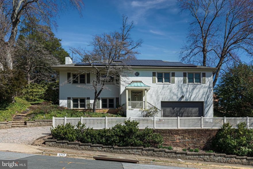 Nestled in the coveted River Crest community, this all-brick residence seamlessly blends timeless elegance with modern convenience. A beautifully maintained exterior welcomes you, with a paver-accented driveway leading to the two-car garage, while lush landscaping and mature trees provide a picturesque setting. Thoughtfully expanded and beautifully updated, this home offers an inviting atmosphere, abundant natural light, and a layout designed for both everyday living and effortless entertaining.

Inside, hardwood floors extend throughout the main level, enhancing the warmth and character of the space. The heart of the home is the stunning, renovated kitchen—featuring granite countertops, professional-grade appliances, and a casual dining area. The kitchen flows into an oversized dining room, where a wood-burning fireplace creates the perfect ambiance for hosting gatherings. The adjoining Great Room, a striking addition to the original home, offers floor-to-ceiling windows and seamless access to the backyard oasis. Step outside to a private retreat with a patio, pool, and serene sitting area, all surrounded by lush greenery.

This level also hosts the primary suite, complete with a private bath, along with three additional bedrooms serviced by a well-appointed hall bath. 

The lower level is designed for both relaxation and entertainment, featuring a spacious rec room with a built-in wet bar, a projector with a 120" screen for movie nights, and a cozy wood stove that adds warmth and ambiance. After a long day, unwind in the private sauna, located just off the full bathroom. This level also includes a laundry room and direct access to the ground-level two-car garage, which is equipped with an EV charging station for added convenience.

Sustainability meets efficiency with owned and fully paid-for solar panels, significantly reducing monthly energy costs. Recent updates include fresh interior and exterior paint (2025), new Great Room windows (2024), a boiler and copper piping (2023), a complete kitchen renovation (2022), and an HVAC system (2018).

Located just minutes from the GW Parkway, this home offers an unbeatable Arlington lifestyle with easy access to Washington D.C., Reagan National Airport, and Tysons Corner. Enjoy nearby shopping, dining, parks, walking and biking trails, and premier golf and country clubs. Served by top-rated schools—Jamestown Elementary, Williamsburg Middle, and Yorktown High—this is a rare opportunity to own a home that perfectly balances comfort, convenience, and charm.