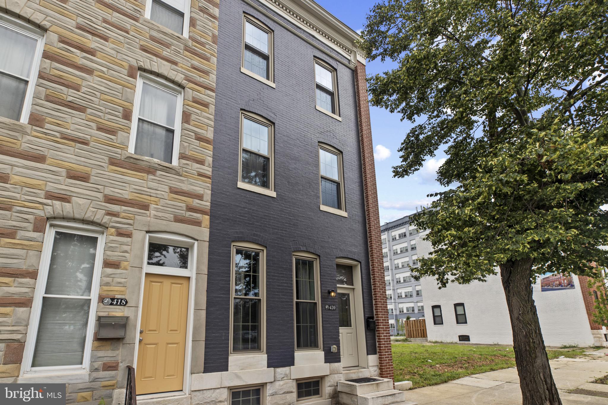 Price reduced! Join us at our next open house on 12 Oct 2 -4 PM.  Just cross the bridge from Mt. Vernon  to discover Johnston Square only one block away. This "next hot neighborhood" has arrived. Over the last three years, the area has undergone dramatic improvements and more developments are underway. If you have not been here for a while, you will me amazed. There is a new Pratt library and many new and restored residential buildings.  420 E. Biddle is an opportunity to purchase a beautifully restored townhouse unlike any other at a price you won't find elsewhere.  This complete luxury renovation was designed and built for the owner to be his ultimate dream home. This is not a typical commercial flip. Its many quality features include red oak floors and tall ceilings throughout the house.  Many original features, like its striking staircase were retained and enhanced with period designs. It features custom millwork and some antique chandeliers and light fixtures. There are several antique mantles and some exposed brick walls. While the home is open and airy, it has a classic but flexible floor plan. It offers an elegant yet cozy formal dining room. The primary suite occupies the second floor. It includes a large designer bath with a soaking tub, a spacious shower, and an oversized custom vanity. The floor and shower tiles are marble. This bathroom is very bright with its many windows. The laundry is conveniently located in this area. The primary suite also features a bonus space which is currently used as a sitting room or den. It could also be used for many other purposes such as a dressing room or an office. The top floor is the guest suite. Its layout mirrors the primary area.  Its bonus room could be used as a third bedroom. The third floor bathroom is also spacious and features a soaking tub and walk in shower. This area has a separate heating and air conditioning system. The bright and spacious kitchen is out of a dream.  It features custom cabinets - some with glass doors - and granite counter tops. The appliances are top quality stainless steel with gas cooking. The leaded glass entrance leads to a private fenced back yard. The large finished basement is tall and dry. This home has it all and is priced so much lower than similar homes nearby.