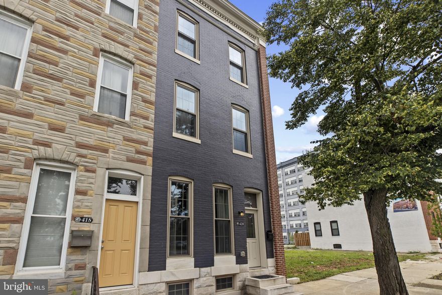 Price reduced! Join us at our next open house on 12 Oct 2 -4 PM.  Just cross the bridge from Mt. Vernon  to discover Johnston Square only one block away. This "next hot neighborhood" has arrived. Over the last three years, the area has undergone dramatic improvements and more developments are underway. If you have not been here for a while, you will me amazed. There is a new Pratt library and many new and restored residential buildings.  420 E. Biddle is an opportunity to purchase a beautifully restored townhouse unlike any other at a price you won't find elsewhere.  This complete luxury renovation was designed and built for the owner to be his ultimate dream home. This is not a typical commercial flip. Its many quality features include red oak floors and tall ceilings throughout the house.  Many original features, like its striking staircase were retained and enhanced with period designs. It features custom millwork and some antique chandeliers and light fixtures. There are several antique mantles and some exposed brick walls. While the home is open and airy, it has a classic but flexible floor plan. It offers an elegant yet cozy formal dining room. The primary suite occupies the second floor. It includes a large designer bath with a soaking tub, a spacious shower, and an oversized custom vanity. The floor and shower tiles are marble. This bathroom is very bright with its many windows. The laundry is conveniently located in this area. The primary suite also features a bonus space which is currently used as a sitting room or den. It could also be used for many other purposes such as a dressing room or an office. The top floor is the guest suite. Its layout mirrors the primary area.  Its bonus room could be used as a third bedroom. The third floor bathroom is also spacious and features a soaking tub and walk in shower. This area has a separate heating and air conditioning system. The bright and spacious kitchen is out of a dream.  It features custom cabinets - some with glass doors - and granite counter tops. The appliances are top quality stainless steel with gas cooking. The leaded glass entrance leads to a private fenced back yard. The large finished basement is tall and dry. This home has it all and is priced so much lower than similar homes nearby.