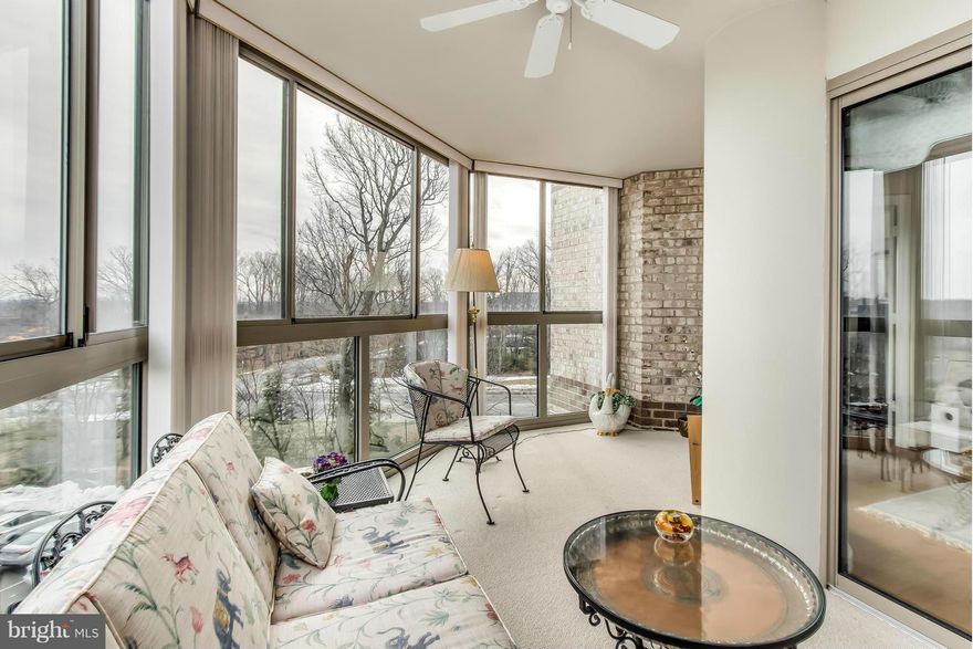 $5,000 Decorating credit at closing!   Indoor Garage Parking space included with the purchase of this exclusive 3 bedroom end unit with panoramic views of nature.  Panoramic views  from your extra large glass enclosed patio are steps from  the living area with gleaming hardwood floors, lots of storage, spacious dining room, eat in kitchen and a majestic master suite/sitting area.