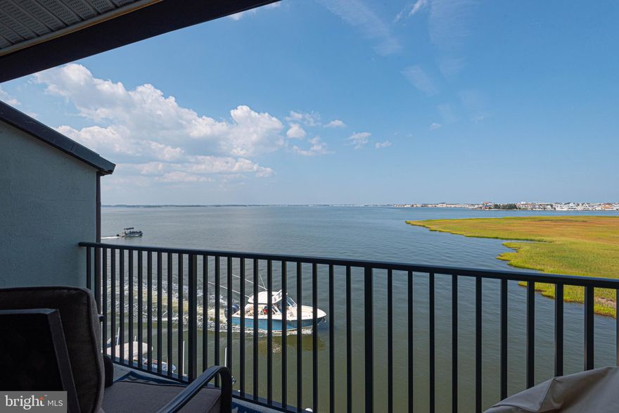 Experience the epitome of coastal living with this captivating Bayfront retreat condo in the heart of Ocean City! Savor awe-inspiring panoramic views of the tranquil Assawoman Bay right from your private balconies. This remarkable two-bedroom, two-bathroom condo is a true gem, complete with the coveted bonus of your very own boat slip #24–an unparalleled rarity. Nestled in a serene neighborhood, this beach home is perfectly situated just a stone's throw away from Ocean City's fine dining establishments, including the renowned Liquid Asset. Its close proximity also allows you to take advantage of everything 94th Street has to offer, from parks, stores, and the OC Art League, which hosts many events, to a convenient boat ramp for all of the family's water sports. This home is not just a property; it's an investment in your coastal dreams. Whether you're seeking an investment opportunity or you're a water enthusiast at heart, this is the ideal haven for you. Step inside to discover an inviting open-concept layout on the first floor. The galley-style kitchen boasts brand-new granite countertops. One of the bedrooms serves as a bunk bedroom, comfortably accommodating up to four guests. There's a tub-and-shower combo bathroom on this level.
Venture to the upper floor to find the main bedroom, an oasis of its own, featuring a private balcony that invites you to soak in the breathtaking bay vistas. The newly renovated modern bathroom with a walk-in shower adds a touch of elegance to your daily routine. This community offers resort-like amenities, including a heated saltwater swimming pool, ensuring you have endless opportunities to unwind and soak up the sun. Plus, this condo comes with two coveted parking spaces, one of which is located under cover. This building is also easily accessible with an elevator for all the residents. Don't miss your chance to own a piece of paradise in Ocean City, where breathtaking views and convenient waterfront living unite in perfect harmony. Your coastal retreat awaits! Now is time to "Invest In The Beach Lifestyle."