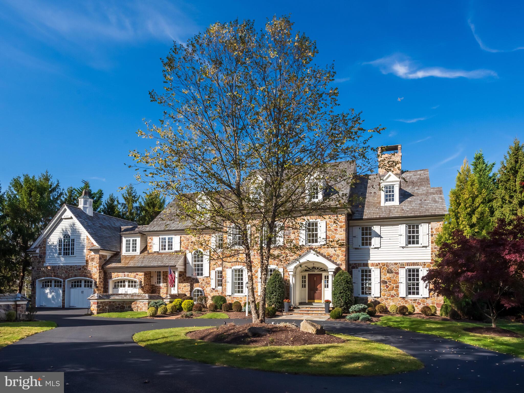 SHANGRI-LA Found— this paradise combines incomparable golf course, open space and sunset views; unparalleled outdoor relaxation and entertainment areas; and an impeccably appointed, stone-accented, custom residence-(built by renowned builder, Donald Pohlig, for himself.) Posed with grand serenity at the end of a secluded court at Applebrook’s custom manor homes, the circle entry gracefully opens to the perfectly sized, park-like .8 acre haven. The ample parking area is bordered by an oversized 2 car, detached carriage-style garage w/epoxy floor/work area/stylish 1BR/1BA guest qtrs. above, and the oversized, 3 car main garage w/epoxy floor/custom golf center cabinetry. Exceptional craftsmanship, inspired design and artisan quality are on vivid display, inside and out, upon your arrival. Attention-grabbing upgrades like gleaming site fin. hardwood floors and updated lighting abound. A gracious foyer, accented by elliptical arches, Gothic transoms and a grand staircase, opens to an inviting, sunlit living room w/marble FP and distinctive, windowed, grand piano alcove. An opposite foyer opening leads to the exquisitely appointed formal dining room, butler’s pantry, household office nook/blt.ins. Continue to a superb, gourmet kitchen boasting custom cabinetry, gorgeous granite counters/large island/breakfast bar, upscale appliances like Thermador 6 burner/griddle/oven, DW, Blt.in refrig, pantry and more! The special, well-windowed morning rm, adjoining family rm and distinctive library/study, all have transcendent rear views of spectacular sunsets and golf course glory! Bespoke quality features like the family room’s coffered ceiling/eye-catching, custom FP/elegant wet bar and library/study’s refined cherry moldings and built-ins set this home apart. Even the sizable mudrm is outstanding w/lge. closets, rear stairs AND the perfect pet bath center! Informal/formal powder rms are comfortably integrated into the main floor. A magnificent, second floor primary retreat displays a genteel luxury with foyer entry, generous bedroom, well-outfitted dual wlk.in closets/dressing area, and sumptuous primary bath. Gaze over singular morning vistas from the blt.in window seat as you enjoy a perfect mimosa--fresh juice and champagne conveniently chilled in this suite’s blt.in refrigerator drawers! 3 Large BRs/En-Suite BTHs, computer study center, whimsical full laundry rm w/2 washers/2 dryers/blt.in ironing board/chandelier, and BR 5/BTH 5--full in-law/au-pair ste complete this 2nd level! The suite is designed with great rm/bedrm/full bath/wlk.in closet. This great rm, endowed with entrancing rear golf course/tree views and divine light, is utilized as the studio by current artist-owner. Ascend to the unfinished 3rd level, offering fantastic storage/built-ins/cedar closet/HVAC space w/possible future finish area. The resort-like, view-entranced, rear stone patios, grill kitchen center, glistening in-ground heated pool/spa, stone outdoor firepl., pergola, and charming pool house w/firepl. invite noteworthy entertaining and world-class relaxation—truly magnificent! Finally, a lavish, walk-out lower level offers a professionally styled fitness center, incredible wet bar, game/billiard area, commodious great rm w/blt.ins/media area, craft/play rm (future wine rm?), storage rm, sauna, and bath/steam shower—perfect after your work-out and accessible from rear pool area! Meticulous owners completed extensive updates/improvements as needed--new roof (all buildings), 22 new windows, whole house Generac, prof. landscaping/front & rear accent lighting/hardscaping, pool tile renovations/upgraded pump & heating system, EV charger and MUCH more! With convenient, sought-after Applebrook location, nearby E. Goshen Park/trails and every possible area amenity within minutes, this special property is a rare find-a blend of craftsmanship and artistry, framed by the designed beauty of Applebrook Golf Club and the sylvan glory of nature-Superlative!