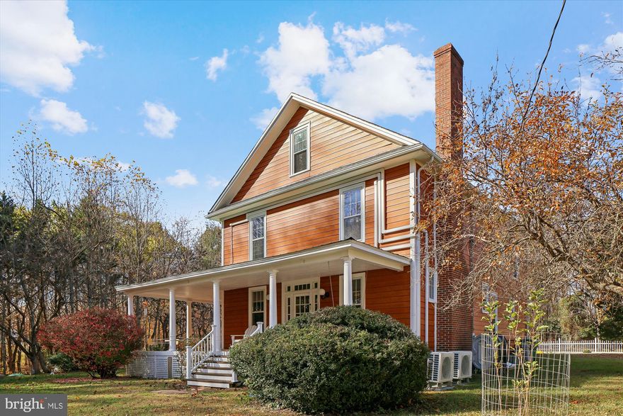 Quietly situated at the top of Walnut Hill, just outside La Plata’s town limits, this classic Southern Maryland farmhouse offers nearly eight acres of mostly wooded land, providing space, privacy, and versatility. It’s a rare chance to own a La Plata home with acreage that combines historic charm, modern comfort, and potential for future growth. Built in the 1930s, the home has been carefully maintained and updated to suit modern lifestyles. Inside, spacious rooms feature wood floors, plenty of natural light, and ample storage. The layout includes four bedrooms and two and a half baths, suitable for daily living, hosting guests, or multigenerational living. An additional room works perfectly as a home office, library, or creative space, with high-speed Fios internet ensuring reliable, easy remote work in Southern Maryland. The primary bathroom has a heated floor, adding quiet comfort that harmonizes with the home’s character. Above the main level, a large unfinished attic offers promising potential for expansion—whether as extra bedrooms, a studio, or private quarters—giving valuable space for future growth. The land around the house truly distinguishes this property. With nearly eight acres, it’s ideal for gardens, small-scale farming, outdoor projects, or keeping chickens, goats, or engaging in hobby farming. The privacy and quiet offer a tranquil lifestyle, with the possibility of adding another home site or family compound, subject to due diligence. This flexibility is rare among La Plata properties and adds long-term value beyond the home. The setting beautifully changes through all four seasons: winter’s snowfall creates a peaceful scene; spring’s blooming trees soften the view from the wraparound porch; summer’s mature trees provide shade; and fall’s vibrant colors turn the woods into a seasonal spectacle. The porch extends around the front and sides, serving as an outdoor extension of the living space, perfect for coffee, relaxing afternoons, or evening gatherings. Ceiling fans keep outdoor spaces comfortable year-round. Despite its privacy and spacious land, the property is conveniently located only minutes from Target, grocery stores, Starbucks, and local coffee shops—combining country serenity with easy access to amenities. It’s a secluded retreat that remains connected to town. More than just a farmhouse on land, this four-season Southern Maryland property is ideal for those valuing space, privacy, and long-term flexibility. Whether you envision homesteading, working remotely, expanding in the future, or simply enjoying a peaceful setting near town, this La Plata acreage offers an increasingly rare opportunity.