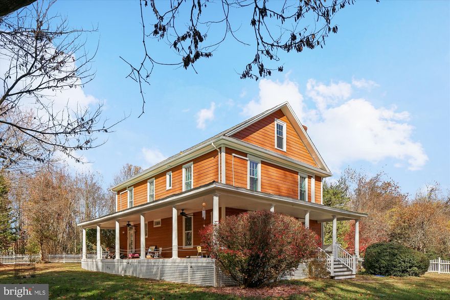 Quietly situated at the top of Walnut Hill, just outside La Plata’s town limits, this classic Southern Maryland farmhouse offers nearly eight acres of mostly wooded land, providing space, privacy, and versatility. It’s a rare chance to own a La Plata home with acreage that combines historic charm, modern comfort, and potential for future growth. Built in the 1930s, the home has been carefully maintained and updated to suit modern lifestyles. Inside, spacious rooms feature wood floors, plenty of natural light, and ample storage. The layout includes four bedrooms and two and a half baths, suitable for daily living, hosting guests, or multigenerational living. An additional room works perfectly as a home office, library, or creative space, with high-speed Fios internet ensuring reliable, easy remote work in Southern Maryland. The primary bathroom has a heated floor, adding quiet comfort that harmonizes with the home’s character. Above the main level, a large unfinished attic offers promising potential for expansion—whether as extra bedrooms, a studio, or private quarters—giving valuable space for future growth. The land around the house truly distinguishes this property. With nearly eight acres, it’s ideal for gardens, small-scale farming, outdoor projects, or keeping chickens, goats, or engaging in hobby farming. The privacy and quiet offer a tranquil lifestyle, with the possibility of adding another home site or family compound, subject to due diligence. This flexibility is rare among La Plata properties and adds long-term value beyond the home. The setting beautifully changes through all four seasons: winter’s snowfall creates a peaceful scene; spring’s blooming trees soften the view from the wraparound porch; summer’s mature trees provide shade; and fall’s vibrant colors turn the woods into a seasonal spectacle. The porch extends around the front and sides, serving as an outdoor extension of the living space, perfect for coffee, relaxing afternoons, or evening gatherings. Ceiling fans keep outdoor spaces comfortable year-round. Despite its privacy and spacious land, the property is conveniently located only minutes from Target, grocery stores, Starbucks, and local coffee shops—combining country serenity with easy access to amenities. It’s a secluded retreat that remains connected to town. More than just a farmhouse on land, this four-season Southern Maryland property is ideal for those valuing space, privacy, and long-term flexibility. Whether you envision homesteading, working remotely, expanding in the future, or simply enjoying a peaceful setting near town, this La Plata acreage offers an increasingly rare opportunity.