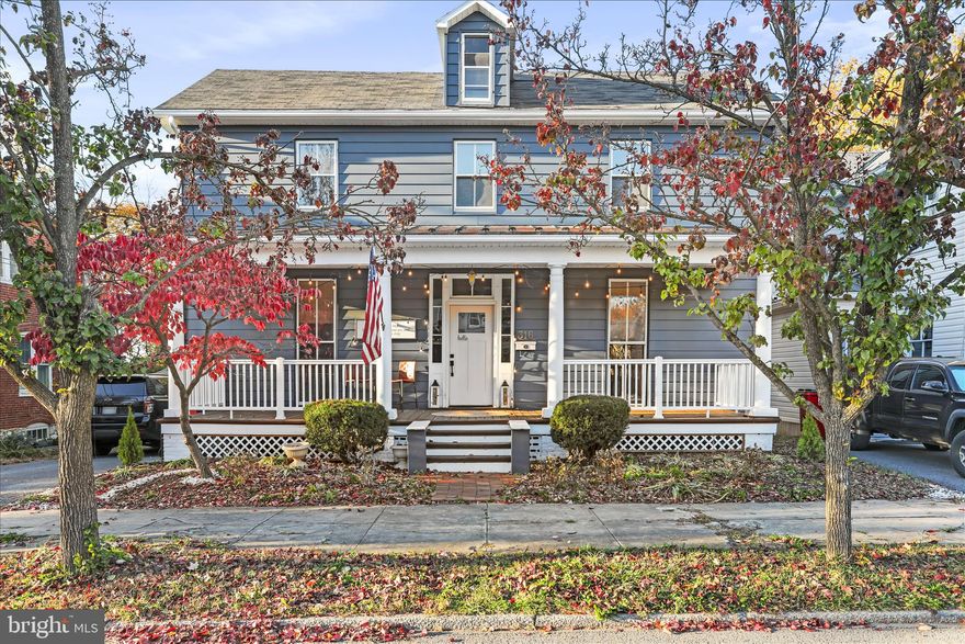 “Historic Bones, Modern Soul” - Nestled in the heart of Charles Town, this timeless Colonial blends classic character with modern-day comfort. Just steps from downtown’s shops, restaurants, farmers markets, and festive seasonal events, it offers the perfect balance of charm and convenience. Inside, original hardwood floors stretch throughout a spacious, light-filled layout. The welcoming foyer, anchored by a grand staircase, sets the tone for the home’s warm and elegant feel. The living room is generously sized with oversized windows, flowing seamlessly into a formal dining room framed by floor-to-ceiling glass - ideal for entertaining or quiet evenings in. The renovated kitchen is a true showstopper: stainless steel appliances, a farmhouse sink, freshly painted cabinetry, and ample prep space for multiple cooks. A full bath and laundry area complete the main level for added ease. Upstairs, you’ll find three comfortable bedrooms, a full bath, and a flexible bonus room - perfect as a home office, walk-in closet, playroom, or creative nook. A walk-up, floored attic offers even more storage potential, while the full unfinished basement invites future expansion. Outdoors, enjoy a level lot with a charming backyard garden space ready for summer blooms, and a front porch made for catching evening breezes. Recent updates include heat pumps, gutters, and electrical which all have been completed within the last five years, making this home truly move-in ready.