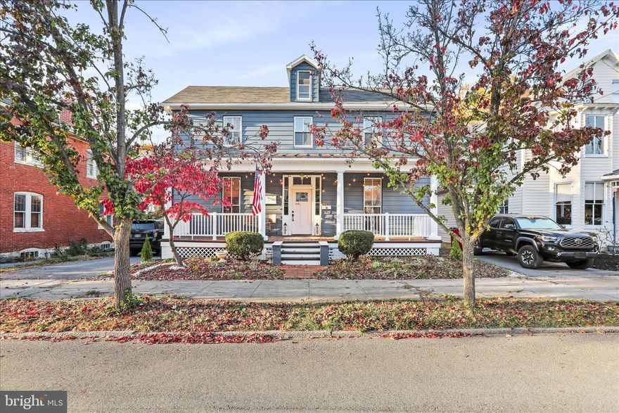 “Historic Bones, Modern Soul” - Nestled in the heart of Charles Town, this timeless Colonial blends classic character with modern-day comfort. Just steps from downtown’s shops, restaurants, farmers markets, and festive seasonal events, it offers the perfect balance of charm and convenience. Inside, original hardwood floors stretch throughout a spacious, light-filled layout. The welcoming foyer, anchored by a grand staircase, sets the tone for the home’s warm and elegant feel. The living room is generously sized with oversized windows, flowing seamlessly into a formal dining room framed by floor-to-ceiling glass - ideal for entertaining or quiet evenings in. The renovated kitchen is a true showstopper: stainless steel appliances, a farmhouse sink, freshly painted cabinetry, and ample prep space for multiple cooks. A full bath and laundry area complete the main level for added ease. Upstairs, you’ll find three comfortable bedrooms, a full bath, and a flexible bonus room - perfect as a home office, walk-in closet, playroom, or creative nook. A walk-up, floored attic offers even more storage potential, while the full unfinished basement invites future expansion. Outdoors, enjoy a level lot with a charming backyard garden space ready for summer blooms, and a front porch made for catching evening breezes. Recent updates include heat pumps, gutters, and electrical which all have been completed within the last five years, making this home truly move-in ready.