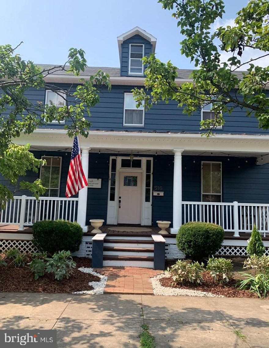 “Historic Bones, Modern Soul” - Nestled in the heart of Charles Town, this timeless Colonial blends classic character with modern-day comfort. Just steps from downtown’s shops, restaurants, farmers markets, and festive seasonal events, it offers the perfect balance of charm and convenience. Inside, original hardwood floors stretch throughout a spacious, light-filled layout. The welcoming foyer, anchored by a grand staircase, sets the tone for the home’s warm and elegant feel. The living room is generously sized with oversized windows, flowing seamlessly into a formal dining room framed by floor-to-ceiling glass - ideal for entertaining or quiet evenings in. The renovated kitchen is a true showstopper: stainless steel appliances, a farmhouse sink, freshly painted cabinetry, and ample prep space for multiple cooks. A full bath and laundry area complete the main level for added ease. Upstairs, you’ll find three comfortable bedrooms, a full bath, and a flexible bonus room - perfect as a home office, walk-in closet, playroom, or creative nook. A walk-up, floored attic offers even more storage potential, while the full unfinished basement invites future expansion. Outdoors, enjoy a level lot with a charming backyard garden space ready for summer blooms, and a front porch made for catching evening breezes. Recent updates include heat pumps, gutters, and electrical which all have been completed within the last five years, making this home truly move-in ready.