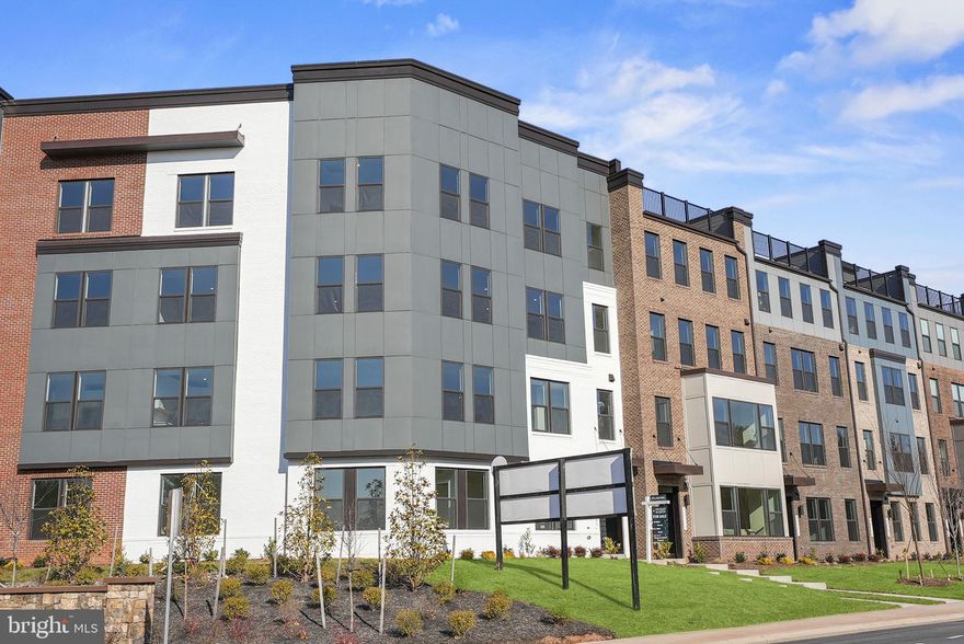 Brand new Stanley Martin 2-level garage condo within walking distance to the Silver Line Metro!
Welcome to The Queensbury Condo at Ashburn Station, where comfort meets style in a unique blend creating an unparalleled living experience. Step inside to find a generously sized primary bedroom on the main level, complete with a sitting area that promises a tranquil retreat. Picture yourself unwinding after a busy day in your own personal hideaway. To streamline your daily routines, an en-suite bathroom and laundry room are readily available.

The upper level introduces a spacious family room, ideal for creating cherished memories with family or hosting memorable gatherings. Bask in the inviting ambiance as natural light pours in through the large windows. Adjacent to the family room, a quaint dining space awaits, ready to elevate every meal into a noteworthy event. Experience the joy of an al fresco lifestyle with a deck that offers countless possibilities for dining, entertaining, or simply basking in the sun. The upper level is completed by another bedroom with a well-appointed hall bathroom. This flexible space, perfect for guests, a home office, or additional family members, promises comfort and privacy to all. The Queensbury Condo at Ashburn Station is a remarkable residence that seamlessly merges comfort, style, and convenience. Photos shown are from a similar Queensbury home. Schedule a tour or stop by and visit our model home today!