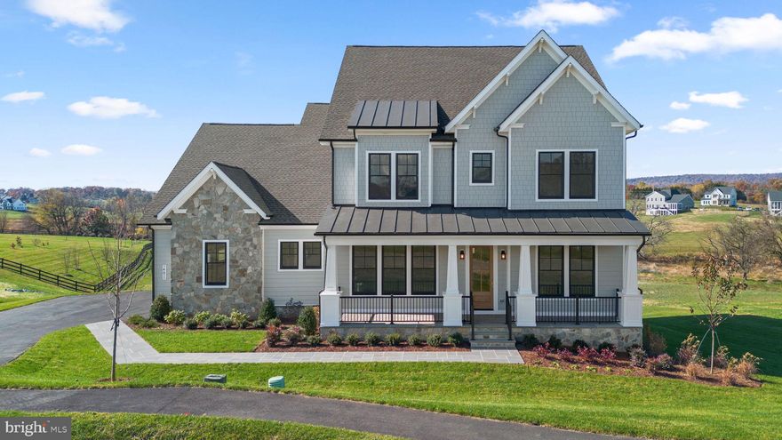Welcome to this exceptional new construction residence by Van Metre Homes - Design + Build.  The highly sought-after Timberneck+ model is ideally situated on a picturesque 5.77-acre homesite in the Glenmore Farm community in Waterford, VA. The VanMetre Design + Build Team meticulously crafted this gorgeous home, sparing no expense on custom luxury details -- enjoy the superior strength and efficiency provided by 6" exterior walls, complemented by high-end finishes, Thermador appliances, and Anderson windows and doors. This stunning Craftsman-style home offers the perfect blend of refined luxury, thoughtful design, and serene countryside living, all within close proximity to Purcellville and the heart of Loudoun County.

A gorgeous flagstone front porch and side-load three-car garage set the tone for the quality and attention to detail found throughout. The main level features an expansive open-concept layout with soaring ceilings and abundant natural light. The gourmet kitchen is a true centerpiece, showcasing quartz countertops, upgraded cabinetry, Thermador appliances including a 6 burner range with griddle & smaller companion oven, Thermador refrigerator with French door top, Thermador wall oven and microwave above,  a large center island, walk-in pantry, and an adjoining casual dining area ideal for everyday living and entertaining. The kitchen opens seamlessly to the spacious great room with fireplace, creating a warm and inviting gathering space.

The main level also includes a private home office with double glass doors, a formal dining room, a mudroom with built-ins, and a main-level bedroom with en-suite bath — perfect for guests or multi-generational living. Step outside to enjoy exceptional outdoor living spaces, including a screened-in porch with an adjacent deck, and peaceful views of rolling open land.

Upstairs, the luxurious primary suite offers a tranquil retreat with dual walk-in closets and spa-inspired bath featuring dual vanities, soaking tub, and separate shower. Additional generously sized bedrooms and well-appointed bathrooms provide comfort and flexibility for a variety of living needs.

The walk-out unfinished lower level offers endless potential for future living space, recreation areas, or additional bedrooms, allowing the next owner to customize to their lifestyle.

Set amidst the natural beauty of western Loudoun County, this property offers privacy, scenic views, and a quiet setting while remaining conveniently close to historic Waterford, Purcellville, local wineries, shops, dining, and commuter routes. A rare opportunity to own a move-in ready brand new luxury home on acreage in one of Loudoun County’s most desirable locations.