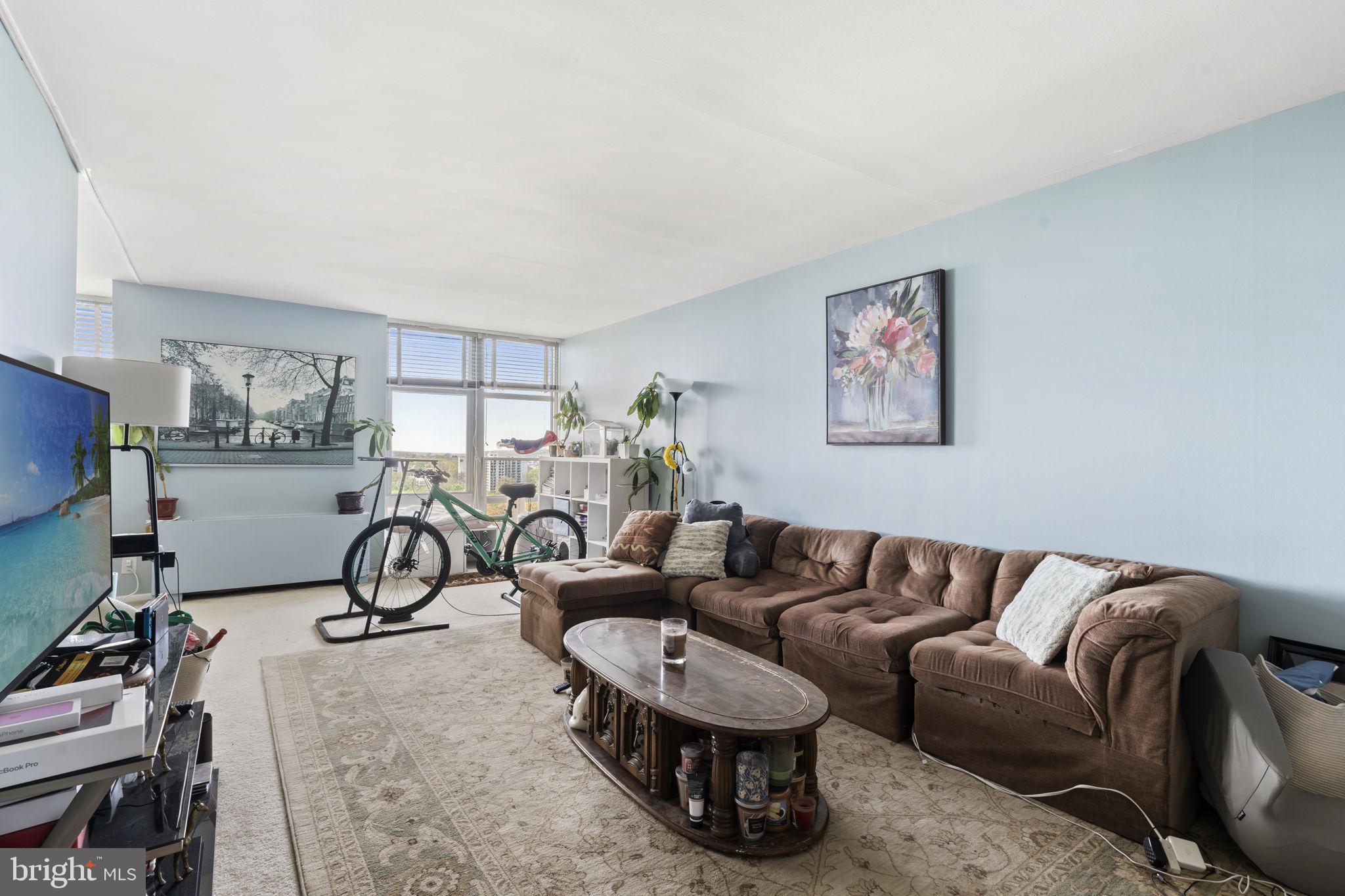 This one bedroom, one bathroom condo is ready for its next owner! Unit 1810 has a beautiful, bright, and airy feel as soon as you walk in. The open living room and dining room allow you to set up the space exactly as you need it. The galley kitchen offers plenty of storage and prep space to cook. Walking towards the bedroom, you'll find additional closet space and storage, as well as the bathroom that also has a stacked washer and dryer. The bedroom is expansive and has plenty of closet space. The building offers many amenities like a 24-hour doorman, pool, gym, and other shops for convenience, like a tailor, right downstairs. Parking is not included with the unit, but there are garage spaces available through the building. The HOA includes all of your utilities and access to the amenities. The building is located near plenty of shopping, public transit, and the Philadelphia College of Osteopathic Medicine (PCOM).