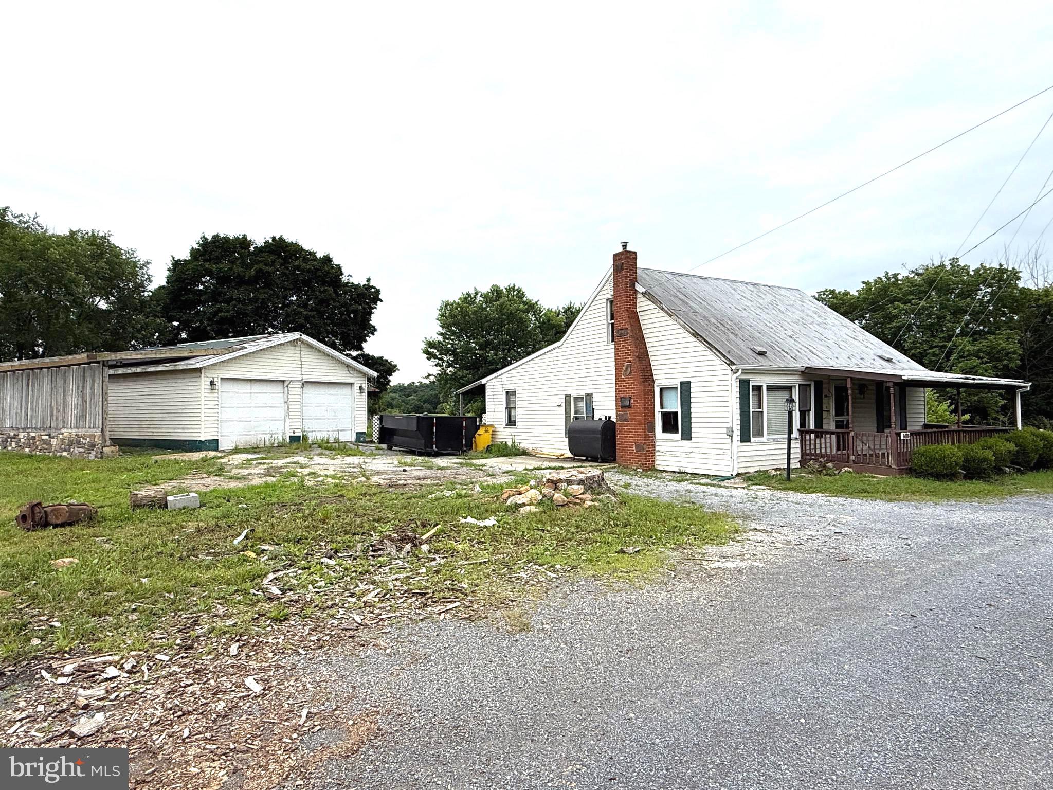 Two parcels totaling 1.14 unrestricted acres. Bring your vision to this 2BR/1BA cape cod because the square footage and layout may lend itself to convert to 3BR's and/or an additional bath. 24X30 detached garage. 22x25 block building/shed. Nice location along Rt. 51. The additional parcel of land with the stone fireplace fronts the road. The lot is deep and runs beyond the fenced area in the back yard. Lots of potential with this property! **The 12x20 gray shed behind the garage is being removed from the property and does not convey**
