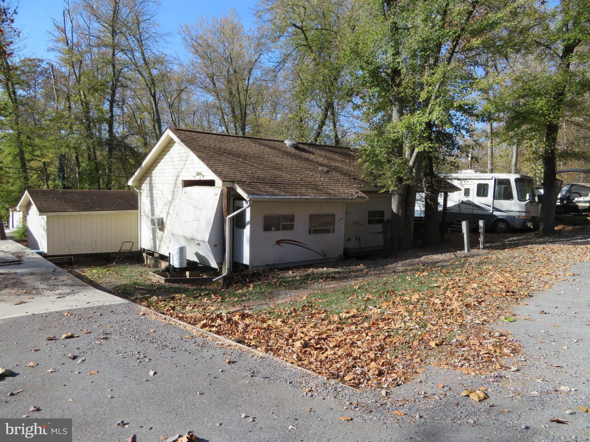 MOTIVATED SELLERS! BRING YOUR OFFERS! $10k PRICE REDUCTION!! A DEAL YOU CAN'T PASS ON!! 3 LOT PACKAGE DEAL....2 lots plus a bonus lot for parking your cars, boat &/or jet ski. Not only do you get the lots, but this deal includes a 2002 JAYCO Eagle RV (sleeps 6) w/a spacious & furnished addition that features a family room & dining area. In addition, the deal includes a 2001 Mountain Aire By Newmar Motorhome (sleeps 5) w/only 36K miles. The motorhome has a Workhorse Chasis Chevy Motor, 340 HP, 8.1L, 496 engine, a new queen size Sterns & Foster mattress, 4 new jacks & a new starter (installed 3 yrs ago). Additional features include a large shared deck w/lots of seating for all your guests, picnic table, deck furniture, extra freezer, extra fridge, 3 TV's, 2 heaters, 3 A/C window units, a 2007 EZ GO golf cart, & a 2003 EZ GO golf cart. Upgrades include a new A/C unit for the JAYCO in 2024, new roof/gutters installed on the pavilion 5 yrs ago, concrete installed 3 yrs ago & new asphalt installed 4 yrs ago on the bonus lot. Minutes to the boat ramp with Potomac River access for boating, fishing & swimming. Yearly membership includes water, pump out, electric, trash and the park amenities such as pools, putt putt, basketball court, tennis court, holiday fireworks for July 4th, car show, carnival, restaurant, playground, ball field and much more. Riverbend RV Park is located close to shopping, I81 & The C&O Canal for hiking & biking. Own this getaway in as little as 3 weeks. Call today before it's gone! **Gated community-pass required for entry. **Riverbend sales are SOLD "AS IS", CASH only and seasonal.** (Direct TV and Frontier Internet available with service install/hookup).
