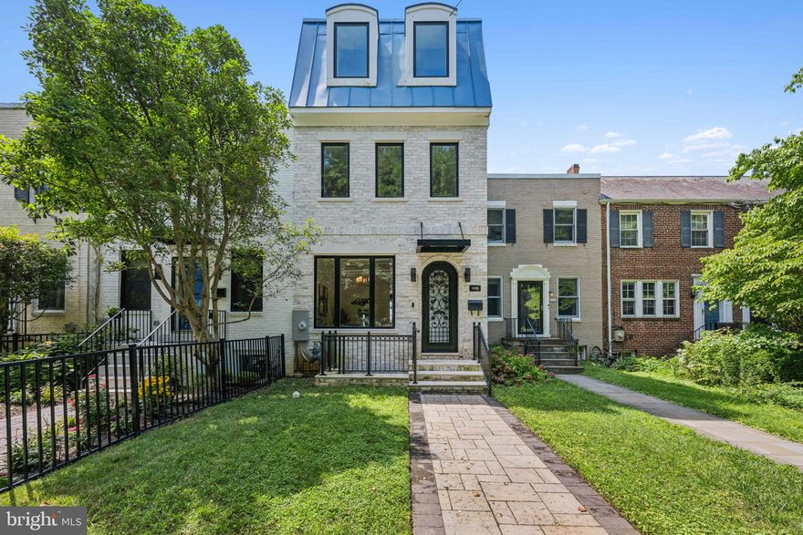 Tucked in the heart of Burleith, just minutes from Georgetown, this newly built residence offers something rarely found in Washington: a true two-home compound.

The main townhome unfolds across four finished levels with five bedrooms and five and a half baths. Nearly 4,000 square feet of modern living space designed for both daily comfort and effortless entertaining.

Large windows and soaring ceilings fill the interiors with natural light. Clean architectural lines and an open layout create an airy, contemporary feel. Multiple balconies and outdoor spaces extend the living areas beyond the walls.

The kitchen is built for both function and presence. Quartz countertops. A generous island with bar seating. Sub-Zero and Wolf appliances.

The living room centers around a sleek ribbon fireplace. Doors open to a spacious rear deck overlooking the patio and garden courtyard.

A finished lower level adds flexibility with a recreation room and private guest suite.

Above it all, the rooftop terrace captures sweeping views of the Washington Monument and the U.S. Capitol.

Behind the main residence sits a rare legal carriage house. A fully independent studio apartment with its own address, kitchen, laundry, and one-car garage. Ideal for guests, extended family, rental income, or a private workspace.

Located moments from the shops, dining, and nightlife of Georgetown and Wisconsin Avenue, as well as the neighborhood’s weekly flea market.

Priced below assessed value. Seller motivated. Bring all offers.