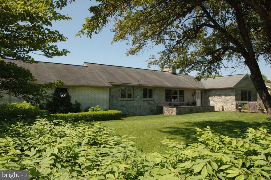 Beautifully maintained 5 bed, 2.5 bath stone front Rancher, with 2 car garage and panoramic views of the countryside. Modern gourmet eat-in kitchen with granite countertops, stainless steel appliances, and tons of storage. Large formal living room with fireplace with coal insert.  Formal dining room with large bright windows.  This home features a large master suite with full bath and good storage closets.  3 additional bedrooms and full bath.  Formal entrance way entering from the patio with seating wall.  Partially finished daylight basement with 2 additional rooms that could be used for family room, den, or bedroom. Home is heated with hot water heat and cooled with central air conditioning.  Enjoy the view overlooking rolling hills from the composite back porch.