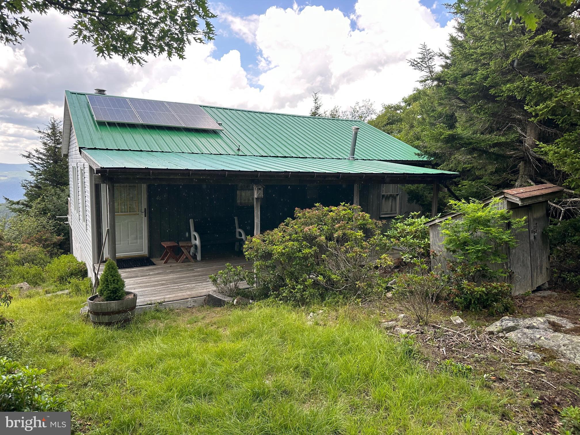 Looking for an off grid escape? This two bed, 1 bath cabin is located on the rarely available West side of Kile Knob with a tremendous western facing mountain view. Full Solar electric system installed 2023! The wood stove keeps the whole cabin warm on those chilly evenings. Propane wall heater installed in the bath for extra comfort and warmth. Internet available by satellite or phone hot spot. Water collection system to cistern. Outside you'll find two sheds, a generator shed and open run-in shed.