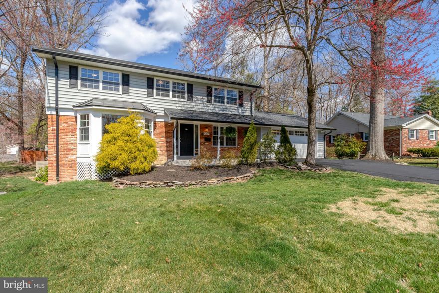 Spacious and versatile! This stunning two-story home offers exceptional living space with a rare first-floor primary suite just one step at garage level. Suite features oversized bedroom, double walk in closets, a double shower,  double vanity and whisper quiet Mitsubishi mini splits.  The beautifully updated kitchen boasts an informal eat-in area, while a formal dining room showcases wood beams and a cozy fireplace. Upstairs, you’ll find four additional bedrooms, including a second primary suite, nursery and hall bath.  The fully finished basement is truly stunning, complete with a wet bar and half bath—perfect for entertaining or movie nights. A bright and airy living space flows seamlessly into a sunroom addition and beyond onto the deck. The deck overlooks a generous backyard with mature trees and plenty of space. This home is a rare find—don’t miss out!