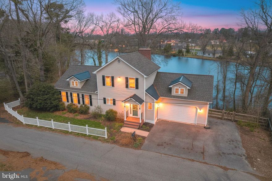 Discover the tranquility and beauty of Moore’s Lake at 89 S Shore Drive in Dover, Delaware—where over 120 feet of direct lake frontage invites you to fully embrace waterfront living. This move-in-ready 4-bedroom, 2.5-bath home has been thoughtfully transformed in 2022 and 2023, blending modern updates with timeless charm.

The exterior immediately impresses with a newly replaced roof accented by two charming dormer windows topped with tin roofing, along with a brand-new fence that enhances the property’s appeal. A natural retaining wall along the lake bank and an additional concrete patio add both function and visual interest to the outdoor space.

Inside, new flooring throughout creates a fresh, cohesive feel. The beautifully updated kitchen features refaced Amish cabinetry and a stunning custom Amish-made two-tier island with a quartz countertop, gas cooktop, soft-close drawers, abundant storage, and bar seating—perfect for entertaining. The laundry room and half bath were strategically relocated to create a welcoming foyer alcove and an elegant dining area highlighted by graceful arched details.

The private owner’s suite is conveniently located on the main level and offers a walk-in closet and a renovated ensuite bath complete with a quartz double vanity, built-in cabinetry, and a luxurious jetted walk-in tiled shower. French doors lead to the deck and patio, connected by a wraparound walkway—an ideal spot to relax and enjoy breathtaking sunsets over the lake.

The expansive great room features a striking brick gas fireplace, soaring cathedral ceilings, large polygon picture windows that flood the space with natural light, and a loft area overlooking the main living space. The former second-floor storage attic has been fully renovated into a climate-controlled office, providing the perfect dedicated workspace with comfort and style.

The lower level offers even more living space, including a spacious family room with a stone wood-burning fireplace flanked by two sliding glass doors showcasing serene lake views. This level also includes a full bathroom, two lakeside bedrooms, and a third bedroom tucked down the hall—ideal for guests or flexible living arrangements.

Located in the desirable Moore’s Lake community, this home offers both privacy and convenience with easy access to Route 13 and Route 1. Enjoy quick trips to Delaware Beaches, Wilmington, Philadelphia, Washington DC, Baltimore, New Jersey, and New York.

Experience the ultimate in lakefront living with this beautifully updated home—an exceptional opportunity you won’t want to miss.