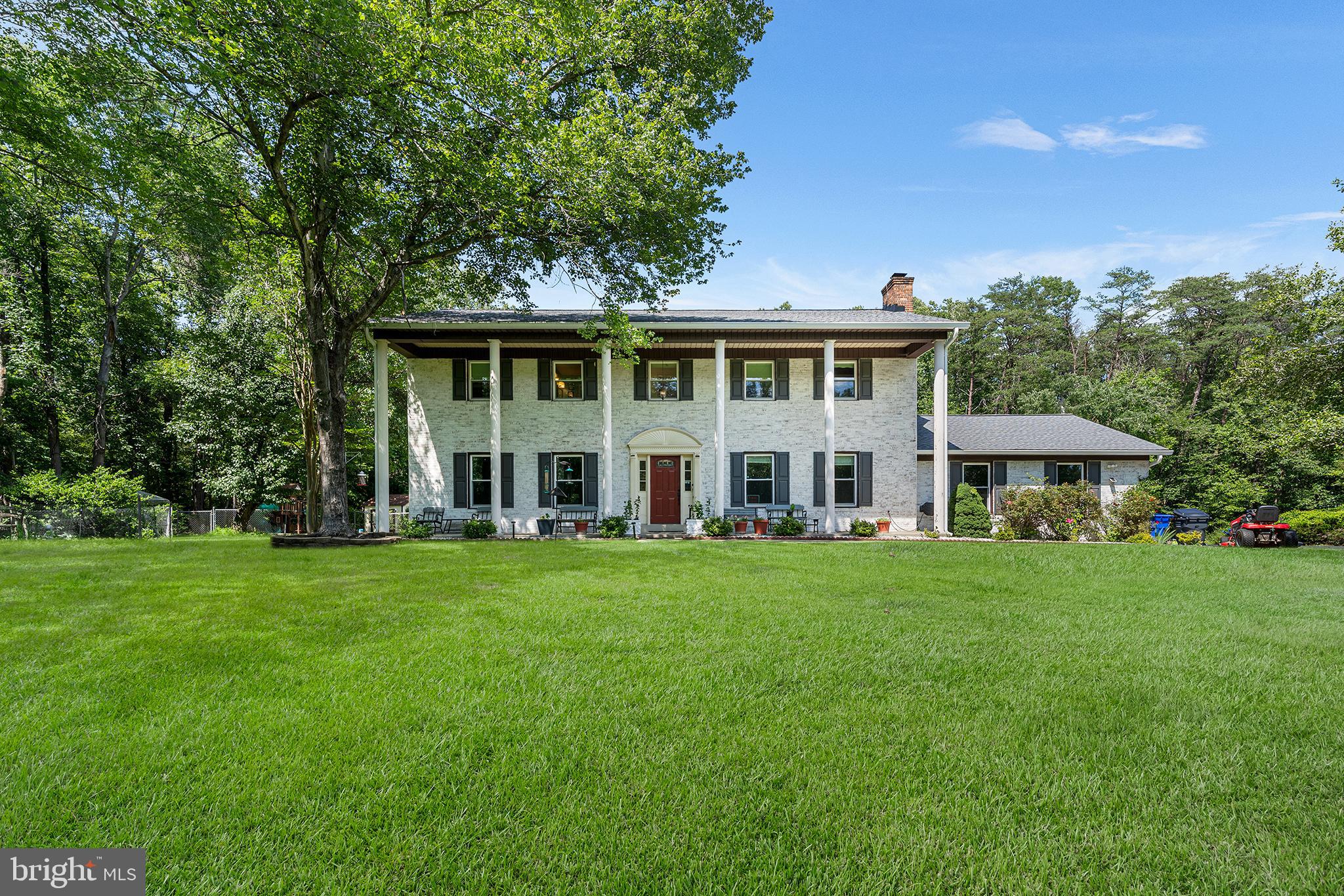 Updated brick-front colonial on 3 spacious acres in a quiet Hughesville cul-de-sac. Newer roof, windows, gutters, and sealed driveway and HVAC. Renovated attached garage with epoxy floor. Custom kitchen with granite, oversized island, and soft-close cabinetry. Four bedrooms upstairs, including large primary suite with sitting area and walk-in closet. Private backyard with deck, stamped concrete patio, and in-ground pool. Multiple sheds, fenced rear yard, fresh landscaping.