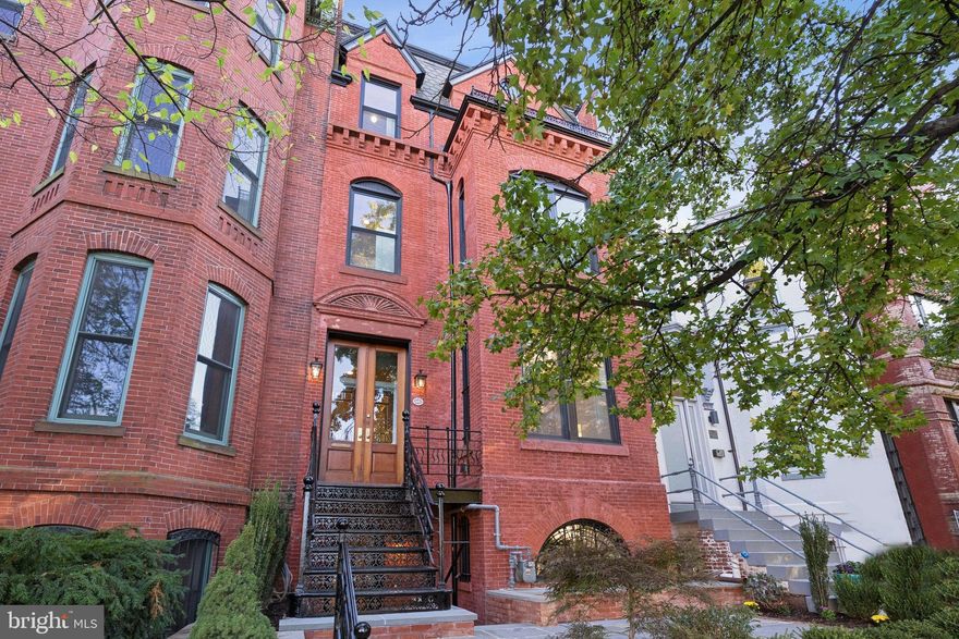 Impeccably restored and reimagined for modern luxury, this grand four-story residence offers approximately 5000 square feet of exceptional living space in the heart of Logan Circle. Seamlessly blending historic craftsmanship with state-of-the-art design, 1514 R Street NW stands as a rare example of timeless architecture renewed for contemporary life.

Step inside to discover elegant details throughout, including restored original wood paneling, pocket doors, and reclaimed heart pine floors. The main level features gracious living and dining rooms—each with working fireplaces and marble hearths—and a designer kitchen by Jennifer Gilmer Kitchens with custom cabinetry, JennAir appliances, and French steel doors opening to a glass deck for seamless indoor-outdoor living.

Six fireplaces, including a gas fireplace in the primary bathroom, add warmth and charm throughout. Upstairs, the private quarters showcase original mosaic tile flooring, Rohl Apothecary fixtures, and a Kingston Brass clawfoot tub. A convenient second-floor laundry and beautifully restored stairway railings complement the home’s period elegance.

The lower level offers a second full kitchen with GE Café appliances, travertine flooring, and a second laundry area—perfect for guests, extended family, or rental income. Thoughtfully designed with exposed brick walls, arched brick doorways, and a light well that fills the space with natural light, the lower level combines warmth, character, and functionality. Outside, two secure parking spaces with an electric roll-up door and EV charger complete the offering.

Every inch of the home has been rebuilt with all new HVAC, plumbing, electrical, and sprinkler, along with tankless water heaters and all new energy-efficient windows. With six French steel doors, restored original details, and modern craftsmanship at every turn, this residence perfectly balances historic character and 21st-century luxury.

Located just steps from Logan Circle, 14th Street dining, and Dupont Circle, 1514 R Street NW delivers the ultimate in refined urban living.