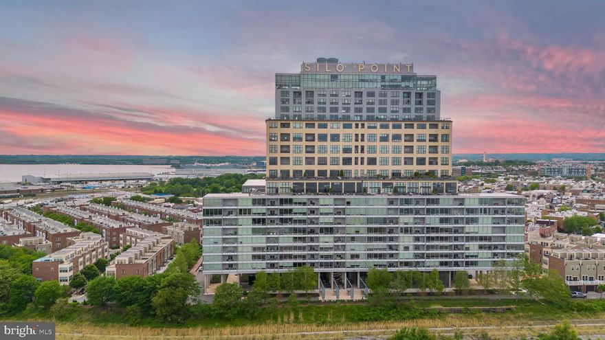 OFFER DEADLINE: MONDAY 9/22, 10 AM |
Welcome to luxury living at Silo Point, one of Baltimore’s premier waterfront communities. This expansive 1,861-square-foot residence offers the perfect blend of modern elegance and urban convenience, featuring two spacious bedrooms and two and a half bathrooms.
From the moment you enter, you're greeted by soaring 10’3” ceilings and dramatic floor-to-ceiling windows that frame breathtaking panoramic views of the city skyline and harbor. Motorized blinds allow effortless control of light and privacy throughout the home.

The open-concept layout flows seamlessly from the living and dining areas to a private balcony—ideal for relaxing or entertaining. A chef’s kitchen anchors the space with granite countertops, stainless steel Viking appliances, and abundant cabinet storage. Rich hardwood flooring runs throughout the home, enhancing its warm, sophisticated ambiance.

The primary suite is a luxurious retreat, complete with a walk-in closet and a spa-inspired bath featuring dual vanities, a deep soaking tub, and a glass-enclosed shower. The second bedroom and ensuite bath offer flexibility for guests, office space, or additional living needs.
Additional highlights include in-unit laundry, two deeded garage parking spaces, and a dedicated storage unit, offering convenience and peace of mind.

Silo Point residents enjoy access to an impressive suite of amenities: a state-of-the-art fitness center, yoga studio, game and conference rooms, and the exclusive 19th-floor Sky Lounge—perfect for taking in the sunset over the harbor. A 24/7 front desk, secure entry system, and bike storage complete the lifestyle offering.

Ideally located in Locust Point, adjacent to Fort McHenry and the Baltimore Peninsula, Silo Point offers convenient access to commuter water taxi stops, public transportation, and major highways. The location provides close proximity to downtown Baltimore, Federal Hill, Camden Yards, and local dining, retail, and parks. BWI Airport is less than 20 minutes away, and Washington, DC is easily reachable for commuters and travelers alike. This residence combines modern comfort with historic charm and outstanding regional connectivity.
Don’t miss this rare opportunity to own in one of Baltimore’s most architecturally iconic communities

| PLEASE NOTE: These images have been virtually un-staged and may show slight discrepancies. (The primary walk-in closet does not have shelving as shown in the lower right and left of the images)|