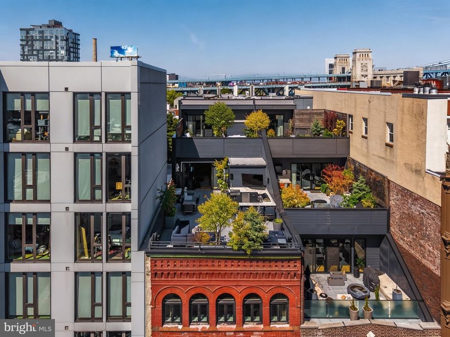 Penthouse 2 at 115 Arch Street, Old City’s iconic condominium. Set atop two historic turn-of-the-century industrial buildings, this trophy duplex encompasses 3,556 interior square feet complemented by two private terraces totaling 1,267 exterior square feet.The bright and airy living area opens directly onto a terrace overlooking Arch Street, offering expansive southern views of the city skyline. At the heart of the home, the kitchen is a masterclass in design by Idea Group and Record e Cucine. It features custom cabinetry and a professional-grade suite of Wolf and Sub-Zero appliances, including a built-in coffee system, wine preservation, and a high-performance range. A custom white oak staircase leads to the second level, where the primary bedroom offers total privacy, completely separated from the rest of the floor. This primary suite serves as a true retreat, outfitted with two generously sized Pianca walk-in closet systems, its own large private terrace, and an en-suite five-fixture bathroom finished with radiant heat flooring and a deep soaking tub and SPA jet. Across the floor, two rear bedrooms offer ample closet space and framed views of the Benjamin Franklin.
115 Arch Street is a premier conversion of two adjacent industrial buildings. In a testament to technological innovation, the property is equipped with a virtual intercom system for remote access. Owners enjoy private automated indoor parking accessed through the rear of the building. For added convenience, cold storage is available in the building lobby. This residence offers the significant advantage of a 7-year tax abatement. Deeded parking on the first floor with a rear garage entry and licensed storage room in the basement. Please note that a second deeded parking space is available at an additional cost off site.