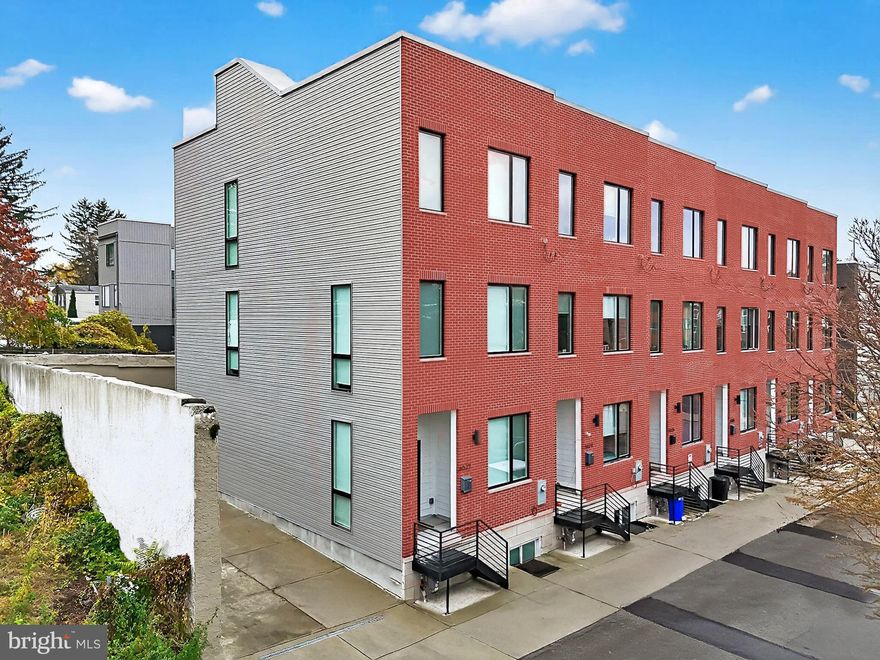 PRIME LOCATION-6522 Magnolia Street is ready to impress. This modern and stylish townhome is like new and available for an immediate settlement.  Located on a quiet tree lined street close to parks, shops, and major routes, this home delivers city convenience with a contemporary feel.  Seven years remain on the 10-year tax abatement! This stunning property boasts 10-foot ceilings, oversized windows, and a bright open layout.  The heart of the home is a SHOWCASE chef's kitchen featuring white shaker style furniture quality cabinetry, stainless appliances, large center island, and open to a dining area and light filled living room with floor to ceiling corner windows- WOW! At days end, retreat to the third level offering a spacious primary suite, well-appointed primary bath, and dual custom closets. An additional guest suite with en suite bath completes this level. One of the highlights of this property is the rooftop deck with sweeping views of the city skyline- the perfect spot for morning coffee or evening gatherings under the stars.  The entry level features a flexible bedroom and full bath that easily adapts to your needs- ideal for guests or a home office. you will also find a mudroom and private access to a one car garage.  This Mt Airy property is close to Chestnut Hill, Fairmont Park, Center City, public transit, and a prime location one block from the Germantown Ave corridor. Incredible opportunity !