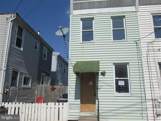 End unit row home has fenced rear yard. Upgrades in the past includes roof and furnace. Upper level has one bedroom, bath and bonus room. Kitchen has breakfast bar and dining room combined . Basement is unfinished with endless possibilities. Close to shopping and entertainment. Easy access to bus lines and Downtown Baltimore.