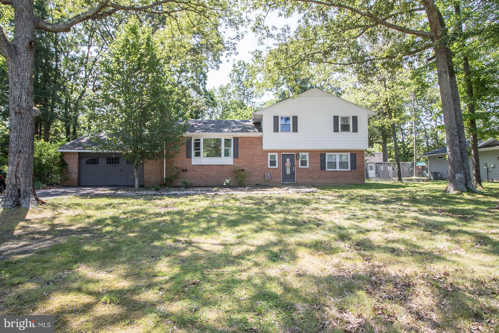 SPACIOUS SPLIT LEVEL HOME IN DESIRABLE TOWN CREEK NEIGHBORHOOD. NICE LARGE LEVEL LOT WITH FENCED BACKYARD AND PLENTY OF PARKING. ORIGINAL HARDWOOD FLOORS ON BEDROOM LEVEL, UPDATED BATHROOMS AND KITCHEN. KITCHEN HAS BEAUTIFUL UPGRADED GRANITE COUNTERS AND OPEN BAR TO DINING ROOM. DINING ROOM LEADS TO A COVERED DECK. GENEROUS LIVING ROOM FEATURES TONS OF NATURAL LIGHT AND A CLASSIC WOOD BURNING FIREPLACE WITH BRICK SURROUND. THE FINAL LEVEL FEATURES 3 BEDROOMS AND 2 FULL BATHS. ENJOY COMMUNITY POOL AT AN ADDITIONAL FEE. JUST MINUTES TO EVERYTHING; PAX RIVER BASE, SHOPPING, SCHOOLS, DINING, PARKS AND MORE! HVAC REPLACED 4/24, REFRIGERATOR 1/24 AND OVEN 11/24.