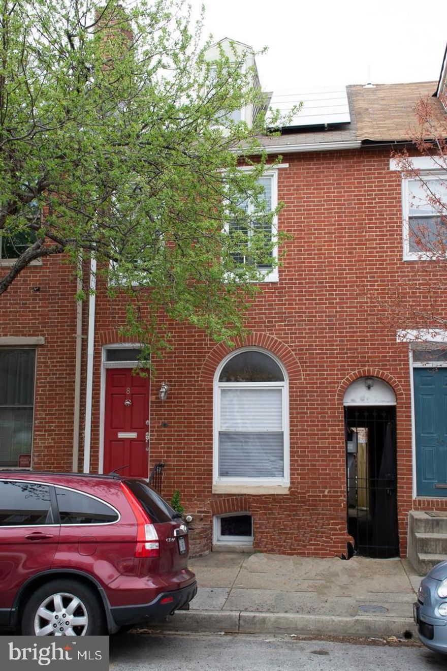 Welcome to 8 Henrietta St! This delightful 2-bedroom, 2-bathroom home, situated in the vibrant heart of Federal Hill, invites you to experience classic charm with its exposed brick, hardwood floors, and tin ceilings, all of which contribute to a warm and inviting atmosphere. On the main level, the living room, dining room, and kitchen seamlessly connect to a full bathroom and a spacious back patio, perfect for entertaining and creating lasting memories. Upstairs, the generously sized front bedroom bathes in sunlight through three large windows, while a versatile walk-through space serves as an ideal office or cozy living area. The potential to transform a third room into a bedroom is located at the back of the house. The basement provides essential unfinished storage space and a laundry area. Schedule a tour today and discover the charm and convenience of 8 Henrietta St. This home is a beautiful blend of historic character and modern amenities, ready to inspire your new journey in Federal Hill!