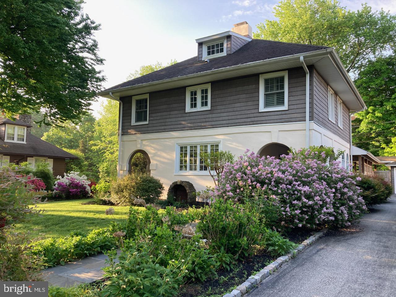 Live in South Wayne in a historic Craftsman/Mission-Revival style home just a short walk to the fabulous schools, library, post office, shops, restaurants, and public transportation of the town of Wayne. This 114-year-old home has been lived in by only 4 owners in the last 55 years, lovingly updated and maintained without losing its warmth and charm. For a lucky buyer looking for something just the right size, this home has 4 bedrooms, an office, an updated kitchen, large family room, hardwood floors and incredible outdoor spaces. The home's arched openings welcome you through a covered porch into a traditional living room with wainscoting, a coffered ceiling and gas fireplace. Glass doors lead to an arch-framed screened porch, perfect for your morning coffee. An elegant dining room with wainscoting and built-ins adjoins the sunny, updated kitchen, which leads to the oversized family room offering plantation shutters and a convenient study area. Pass through the well-designed laundry/mud room, next to the modern powder room, to another covered porch and covered walkway leading to the 2-car garage.
The second floor has a generously-sized primary bedroom with a beautifully-updated bath. There are 2 more large bedrooms and one other room that is currently being used as an office. The hall bath has a tub/shower, updated with a glass surround. All the bedrooms have plantations shutters.
The third floor provides storage areas and a fourth bedroom currently used as a playroom/nursery. The back yard is fully enclosed with attractive fencing.
Midland Avenue is a tree-lined street with varied architecturally-interesting homes in a wonderful neighborhood which hosts PorchFest, progressive dinners, holiday light contests and more. This could be the one, so make your appointment today.