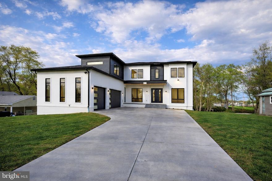Opulux Homes presents a rare pre-sale opportunity to own a custom-designed luxury residence on an expansive .58-acre lot—an exceptional offering in highly sought-after Vienna, VA. Nearly complete, this modern minimalist chic home features premium finishes, a chef’s kitchen with spice kitchen, and a three-car garage. With delivery anticipated in April 2026, this home is now in its final stages of construction and offers a unique opportunity to secure a nearly completed, fully designed residence prior to its full market release.
Spanning over 7,800 square feet, this modern transitional home features 7 bedrooms, 7.5 bathrooms, an upper-level loft, and an oversized three-car garage, thoughtfully designed to balance everyday comfort with elevated living. The striking exterior is defined by floor-to-ceiling Andersen 400 Series windows that flood the home with natural light and create a seamless connection to the outdoors.
Inside, the open-concept layout offers expansive living and dining spaces, a sunlit family room with a linear fireplace, and a main-level bedroom suite ideal for guests or multi-generational living. The chef’s kitchen is complemented by a fully equipped spice kitchen, featuring premium appliances, European-style dual-tone cabinetry, and an oversized quartz island. The main level extends to a covered composite deck, creating a natural flow for indoor-outdoor entertaining. The foyer makes a strong first impression with large-format luxury tile, while the main and upper levels feature elegant natural stained hardwood, and the lower level is finished with premium LVP for durability and style.
The upper level features four spacious en-suite bedrooms, each with walk-in closets, along with a private primary suite designed as a true retreat. The primary suite offers a sitting area with a fireplace, a private beverage bar, and three picturesque windows overlooking the backyard, creating a bright, serene retreat. A walk-in closet with a center island provides boutique-style organization, while the spa-inspired bathroom features dual water closets and an oversized shower with dual rain heads and body jets. A versatile loft with a full picture window completes the level, offering an ideal space for a lounge, workspace, or relaxation.
The fully finished walkout lower level is designed for elevated entertaining and everyday enjoyment, featuring an expansive recreation room, a full bar, a fireplace, a pre-wired media room, two additional bedrooms, and a dedicated exercise room.
As with all Opulux Homes properties, this residence showcases exceptional craftsmanship and attention to detail, featuring 10-foot ceilings on the main and upper levels, 9-foot ceilings in the basement, custom cabinetry, and premium porcelain tile throughout. Highlights include modern railings, tray ceilings, LED ambient lighting, an EV charging outlet, and a high-efficiency HVAC system for year-round comfort. Built with superior quality, the home offers 2x6 exterior framing, upgraded foam insulation, enhanced subflooring, extra-wide foundation walls, PVC trim with James Hardie soffits, and architectural shingles.
Buyers have a limited opportunity to secure the property prior to full market launch. As final finishes are completed, pricing may be adjusted to reflect the finished product.
Ideally located with convenient access to major highways, metro stations, and everyday amenities, this home offers a rare balance of privacy, connectivity, and refined luxury living. Buyers are encouraged to contact the listing agent to learn more and be among the first to tour the home once it becomes available.  Photos shown are of the actual home and include virtual staging to help visualize furnishings and layout.