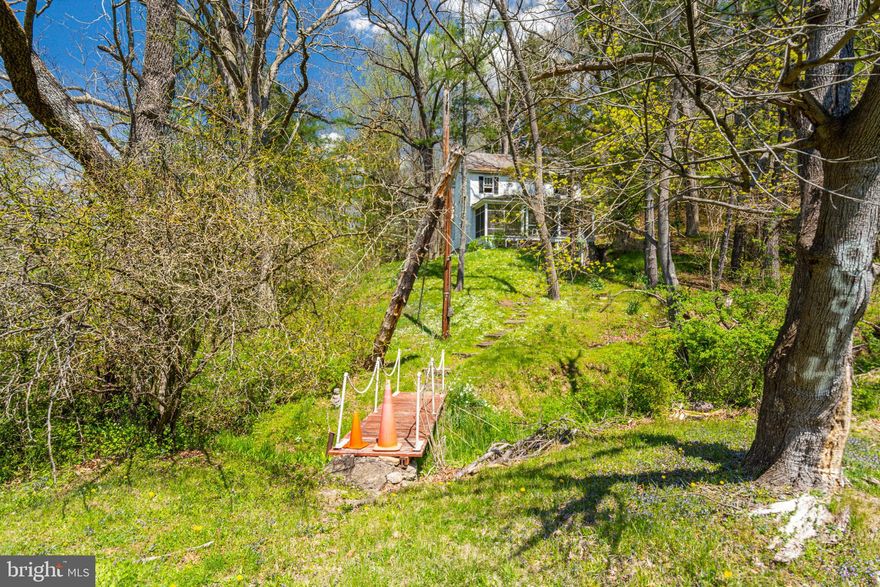 CHARMING COLONIAL NESTLED ON 3.45 ACRES!  Main level features a spacious living room with wood burning fireplace, a large kitchen, and a screen in porch.  The upper level offers 2 bedrooms and 1 full bath.  The basement is improved with stone walls and floors and has a full bath.  Property is being sold As-Is - Seller will make no repairs!