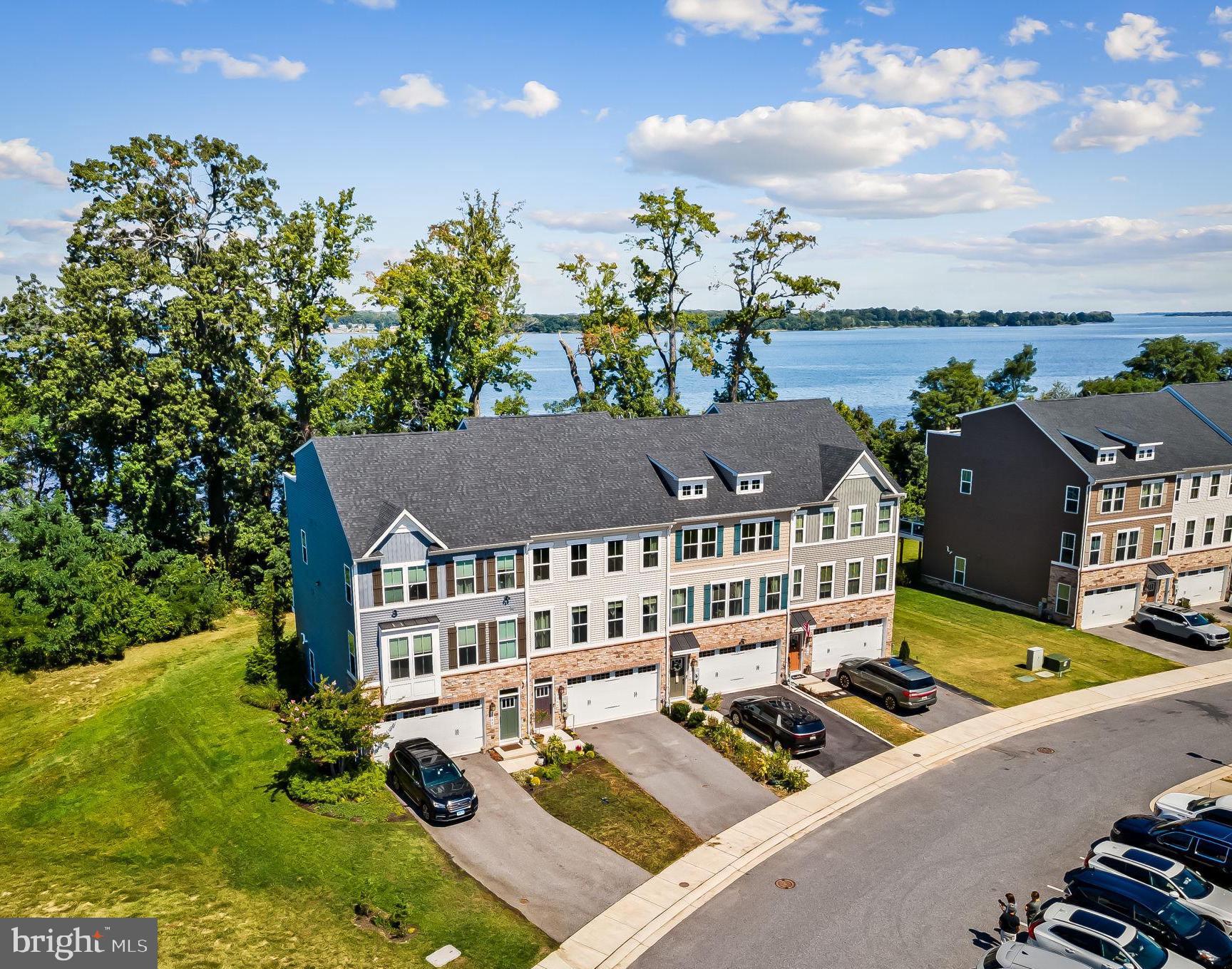 NEW PRICE! Discover waterfront living at its finest with this turn key, modern townhome nestled in the desirable, gated Shaw's Discovery community. The only waterfront home in this community on the market, this 3 bedroom, 3.5 bath home was constructed in 2019-20 and offers so many upgrades and conveniences designed for today’s modern lifestyle.
With approximately 2,600 square feet of living space, the home features a 2 car garage, foyer, full bath upgrade, and large family room on the entry level. From the family room you can access the rear patio and yard . . .a gardener’s delight with native perennial gardens.
Upstairs, an open-concept layout provides a seamless flow from the sunny living room to the gourmet kitchen with 48” cabinets, granite countertops, a gas stove, recessed lighting, and a massive center island perfect for everyday entertaining. Bonus! You’ll love the large custom pantry and built-in home office station. A stylish half bath is also conveniently located on this level. Just off the dining area, a glass door leads to a large maintenance free deck large enough for grilling and dining. From this vantage you’ll enjoy not only the hummingbirds in the native gardens but also a plentitude of American bald eagles soaring overhead. In the fall and winter, once the leaves have dropped, you’ll experience the most beautiful views of the Chesapeake Bay.
Upstairs you will find three bedrooms and two full bathrooms, including a luxurious owners suite with amazing water views, a walk-in closet, and a spa-inspired en-suite bathroom with dual vanities, glass shower and private water closet. The laundry room is also conveniently located on this third level.
Additional upgrades in the garage include upgraded electric for EV charging and specialty coated flooring.
Residents of Shaw’s Discovery enjoy community amenities including a fishing pier, a pavilion/picnic area, walking paths winding through 17 wooded acres and a restorative beach area. Another boat launch is located nearby. The proximity to forest conservation areas and numerous marinas makes it a haven for nature and boating enthusiasts alike. Whether you're seeking a serene retreat or a vibrant coastal lifestyle, this property fulfills every desire. With its prime location just outside of Baltimore, water views, and so many upgrades, this is a rare opportunity to own a truly custom home in one of the area’s most sought-after newer communities.
