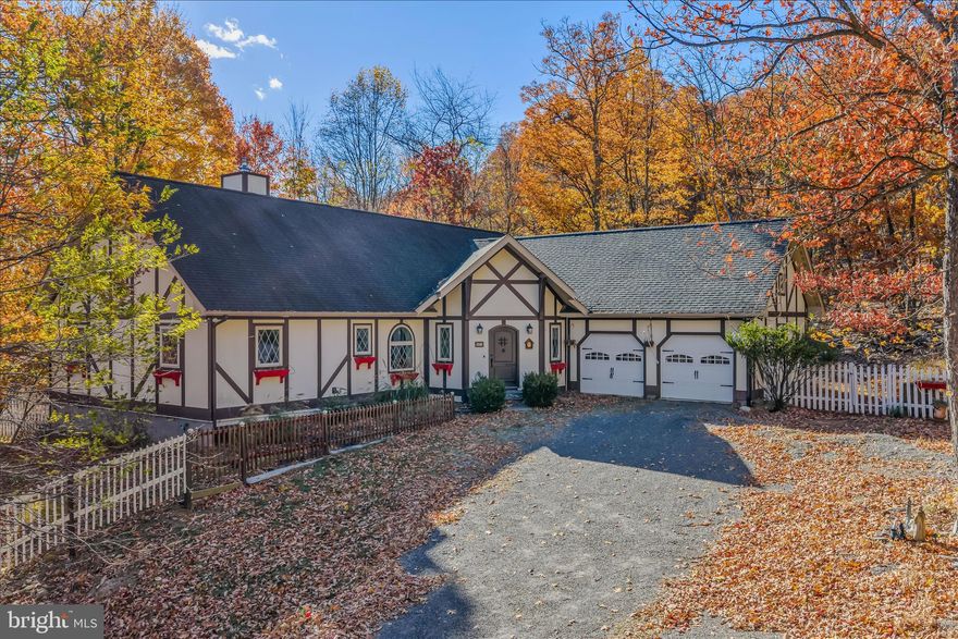 Tudor style rancher home on one level with beautiful design, layout, cathedral ceilings, and a 2 sided fireplace that really brings it all together. There are so many nice features you'll love! The primary bedroom has a walk-in closet, a bathroom with tub, a separate shower, and dual sinks. Along with the walkout deck/patio and screened porch, you'll love this bedroom! Located in the Cacapon East community, this exquisite 3-bedroom, 2.5-bathroom home offers a perfect blend of luxury and comfort. Built in 2008, the home features stunning architecture and hardwood flooring throughout, with plenty of closet space and a floor plan you'll love. Step outside to discover a beautiful outdoor space, complete with a screened patio and deck, perfect for entertaining. Set on a generous 2.073 acre lot on a no-thru street, this property ensures privacy and tranquility. The attached 2 car garage provides easy access to the generous mud room, while the additional greenhouse and fenced garden space offer endless possibilities. Truly a luxurious, warm and inviting home with so many nice features and details, it will make for your ideal forever home, or if you're looking for a getaway for the weekend until you can make it your full time home, it would be perfect!. Lovingly cared for and maintained, just waiting for you to fill the office or turn back into a bedroom, enjoy a nice cup of tea or coffee in the dining room and enjoy the views, or soak in the spacious bath tubs. Tranquil setting and lovely views from the extensive windows throughout. Truly a special home you need to see for yourself while it lasts!
