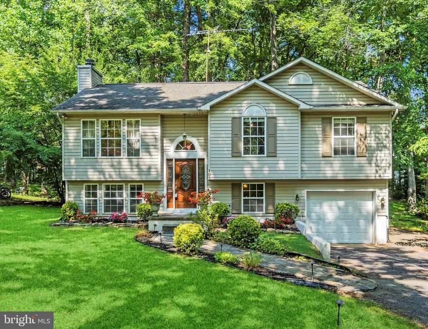 Nestled in a quiet corner of Lake of the Woods, you’ll find this pretty, light filled split foyer to call your own. It features 4 bedrooms, 2.5 baths, a large rec room and built in garage.The heart of any home is the kitchen and yours was remodeled this year.  The kitchen upgrades include new custom white cabinets, some w/ glass display fronts, new refrigerator, stove, microwave, beautiful Quartz countertops, new overhead fan and new vinyl plank flooring. It’s a perfect spot to prepare meals for family and friends. 
The living room has vaulted ceilings and a large picture window that looks over the yard and trees.  There is upgraded glass lighting in the foyer and dining area. There are 3 bedrooms upstairs along with two full baths. The hall bath was remodeled two years ago with a new walk-in shower in place of the tub for easy mobility access.  The brand-new carpet was just installed on 8/7/23 on both levels. 
Downstairs you’ll find a large rec room; the perfect spot to curl up with a good book in front of the fireplace. There you’ll also find the 4th bedroom as well as the laundry room with it large stacked washer and dryer.  There is a built-in garage with extra workbench space for hobbies or woodworking.  The garage has a new steel garage door with auto opener that was professionally installed in May of this year.  The heat pump was replaced in 2016.  Outside you have custom stone walkway,  a wonderful rear deck and large backyard for grilling out or just relaxing in a hammock under the trees.  Here you'll see dozens of Virginia songbirds, chipmunks and the occasional deer pass by. 
Lake of the Woods and its resort -like living has a 500-acre lake plus a smaller 35-acre fishing lake and a pond. There are two swimming pools, numerous beaches for sunning, swimming, water skiing and boat launch access from several locations.  You can play a round of golf at the 18 hole PGA Golf Course with its own Fairways dining and Pro Shop.  Lake of the Woods has an Equestrian Center for the horse enthusiast.  You can also duck into the  Clubhouse for a cool drink or dining indoors on spacious outdoor deck overlooking the picturesque  lake. The Clubhouse can also host events, parties and weddings. There is a Fitness Center and Rec Center, soccer fields and tot lots.  Lake of the Woods has many Clubs with specialty interests such as the Veteran's Club, Pickleball, Gardening, etc. There are seasonal holiday special events like the Big 4th of July celebration with parade, day activities and evening fireworks.  Something for all ages and interests.   
The property is very close to the middle school and not far from the elementary and primary schools. If you ask residents of Orange County why they love living here, they are happy to tell you. It is a friendly place nestled in-between farmland, horse farms, wine orchards and rich in history. You should not miss the exciting Montpellier Horse Races or Oakland Heights Bull Riding Rodeo. The old fashion Orange County Fair is held every summer at the fairgrounds and is a true "Mayberry" experience with its pie baking contest, 4-H Livestock Club competitions, mule pulls and wonderful fair food. Butler Circle is close to restaurants, coffee shops, the library and shopping. Less than 20 minutes to Lake Anna, Culpeper or Fredericksburg and less than 50 minutes to Charlottesville. Orange is home to some of the most beautiful Bed & Breakfasts and wedding venues. We are a hardworking county with our crop production, livestock farms and multiple flower growers. Residents of Orange love our outdoor recreation- golfing, horseback riding, fishing, hunting, hiking, or even skydiving at the Orange County Airport. We are rich in history. We have food festivals, parades, wine tours, wool festivals, sheep dog trials, tractor pulls, paintball parks, Friday night football games, art galleries and plays. You can do as much as you like or nothing at all. What is not to love about living in Orange County VA!?