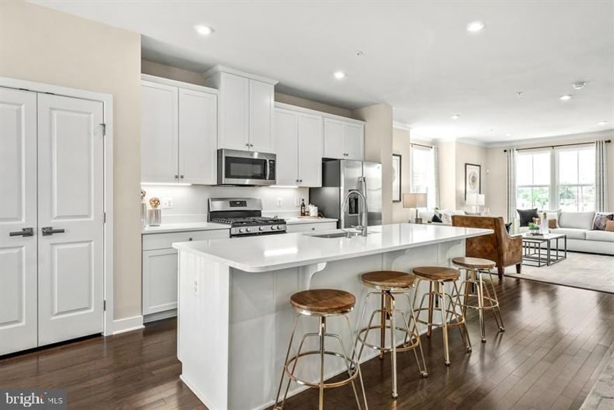 ***TAKE ADVANTAGE OF OUR  FLEX CASH INCENTIVE ***
The largest of Ryan's Composer Series, the Strauss offers the space and customizing details of single-family living with the convenience of a townhome. On the main living level, an enormous Kitchen  featuring an upgraded decorator's palette, a spacious island opens  onto a bright and airy Living Room featuring LVP flooring. The kitchen also features pendant lights, a beautiful backsplash and a gas range. A window-lined Morning Room off the Kitchen provides room for dining. An 18' x 8' deck is located off of the kitchen for outdoor entertainment. Up a flight of stairs designed to be elegant and functional, the upper level boasts three bedrooms, two baths, and a 2nd floor laundry. No need to worry about storage space as generous closets abound in all bedrooms. The Primary Bedroom is a private retreat accented with a tray ceiling and featuring an enormous walk-in closet. The Primary Bath boasts a soaking tub and separate shower with seat.  The lower level has a 4th bedroom with a full bath.