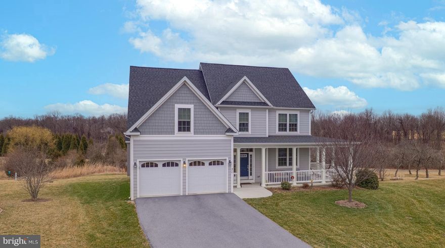 Now available!  Meticulously maintained, custom-built home located in the desirable neighborhood of Deerfield Village and minutes from the local park, shopping center, Shepherd University, and downtown Shepherdstown shops and eateries.  This 4 bedroom, 2.5 bath home features an open floor plan on the main level with a gourmet kitchen and Kitchen Aid appliances, double ovens, granite countertops, ample cabinet space, and a dining area that flows into the spacious family room with fireplace and connects to the outdoor deck space that lends itself perfectly to outdoor grilling and entertaining.

Upon arriving at the home, you will notice the covered wraparound porch complete with furniture space for front porch relaxation.  Entering the front door, you will notice the hardwood flooring that makes its way into the front office room which can also function as a dining room if desired.  This room connects to the gourmet kitchen which openly flows into the spacious family room that features a gas fireplace and connects to the private rear deck.  Upstairs, there is a magnificent primary suite complete with a sitting area, vaulted ceiling, and walk-in closet with complete custom wardrobe shelving.  The primary bathroom features a double vanity plus a separate soaking tub and shower.  Also upstairs are three more nicely sized bedrooms complete with closets and custom wardrobes.  There is a well-appointed full bathroom located off the main hallway that can be utilized by the bedrooms.  Downstairs in the basement area is lots of space to make your own recreation or cinema room.  There is a walkout to the backyard which is located not too far from the community walking trail.  Add in the two-car garage for covered parking plus storage space, and this home is move-in ready and waiting for its new owner.  Book your showing today while this must-see property is available!