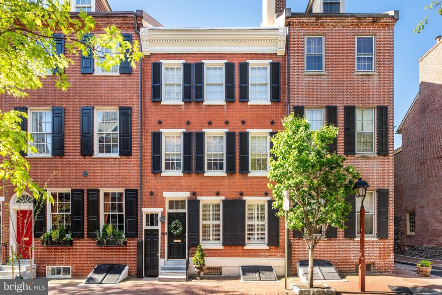 Welcome to 208 Spruce Street, your dream home in the heart of historic Society Hill. This stunning 3 bedroom, 3.5 bath home is located on picturesque Spruce Street and offers the perfect blend of impressive historical architectural details with impeccable modern updates throughout.

Enter the cheery vestibule and continue through one of the many original wood doors, to the inviting living room with gas fireplace, which then flows seamlessly to your dining area, large enough to host dinner parties and holidays. Enjoy a cozy reading nook with two comfortable upholstered seats, storage and gorgeous seagrass wallpaper. The showstopper on this floor is the Joanne Hudson-designed kitchen with custom cabinets, a deep farmhouse sink, paneled Sub-Zero refrigerator, Miele dishwasher, and Wolf side-by-side double oven with 4 burners and middle griddle, as well as a pot faucet over the oven. The island is large enough to seat 4, and in addition, the breakfast area with a lovely banquette, can seat at least 6 for breakfast or an informal dinner. The kitchen provides access to your private outdoor escape. The first floor is complete with a convenient powder room.

Head upstairs and get comfortable in the warm family room/study with oversized windows and sliding glass doors onto a Juliet balcony, which looks out to the garden area. This room features an impressive custom media unit and a fireplace with marble surround (fireplace can be brought back to wood burning use). This floor is complete with your primary suite. The primary bedroom showcases custom shelves and cabinets for all your storage needs, three ample closets, a decorative fireplace with a large mantle and brick surround, as well as a bathroom also designed by Joanne Hudson, which includes a Kohler soaking tub, 4-jet shower with marble-tiled walls, double vanity, and spectacular woven lattice tiles. Continue upstairs and be greeted on the bright third floor sunlit by the hallway skylight, two more bedrooms with original wood doors, and a full bath with glass tile and marble-topped vanity, also designed by Joanne Hudson.

Not to be overlooked is the finished basement, which offers a full bathroom and the ability to be used as an office, guest bedroom, gym, playroom, etc. You will find a full laundry room in the basement as well as ample storage space and your very own sauna.

With original random width pine floors throughout the first and second floors, 10-foot ceilings, abundant character and charm, 208 Spruce Street has been lovingly maintained with attention given to the maintenance of all systems, appliances, and utilities. Within walking distance of Spruce Street Harbor Park and fabulous restaurants such as Zahav, Amada, Buddakan, Malbec, Stella, and more, as well as easy accessibility to 95, 676, the airport, and the Ben Franklin Bridge, make this your next home and love it for many years to come!